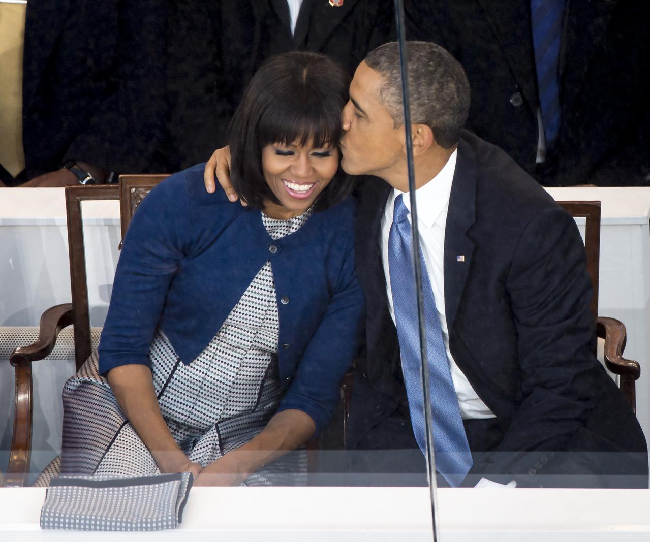 President Barack Obama kisses first lady Michelle Obama while seated in the presidential reviewing stand during the inaugural parade, Monday, Jan. 21, 2013, in Washington. Obama was sworn-in as the nation's 44th President earlier in the day. Photo Credit: (NASA/Bill Ingalls)