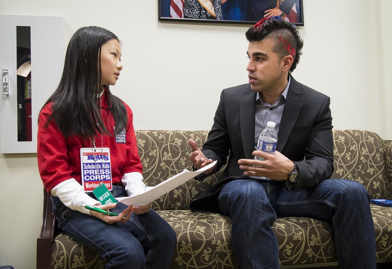 Bobak Ferdowsi, Flight Director, Mars Curiosity Rover, answers questions from Scholastic News young reporter Emily Shao prior to the start of the first-ever State of Science, Technology, Engineering and Math Event (SoSTEM) held at the Eisenhower Executive Office Building, Wednesday, Feb. 13, 2013 in Washington.  Ferdowsi was part of a panel that took questions from a crowd of STEM students.  Photo Credit: (NASA/Bill Ingalls)