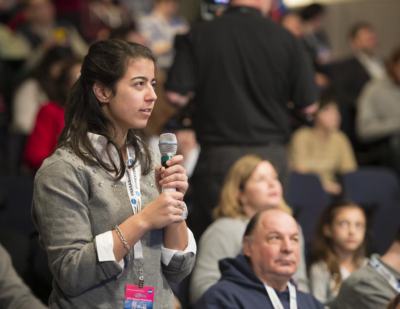 A NASA Social participant asks a question to the astronauts onboard the International Space Station in a live downlink from the ISS at a NASA Social exploring science on the ISS at NASA Headquarters, Wednesday, Feb. 20, 2013 in Washington. Photo Credit: (NASA/Carla Cioffi)
