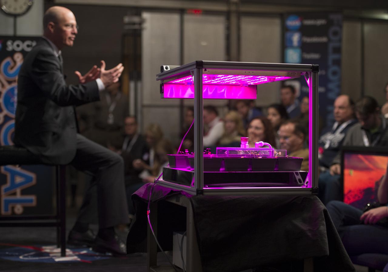 Marshall Porterfield, Life and Physical Sciences Division Director at NASA Headquarters, talks about the human body in microgravity and other life sciences at a NASA Social exploring science on the ISS at NASA Headquarters, Wednesday, Feb. 20, 2013 in Washington. In the foreground is pictured Veggie, a container used for growing plants on the ISS. Photo Credit: (NASA/Carla Cioffi)