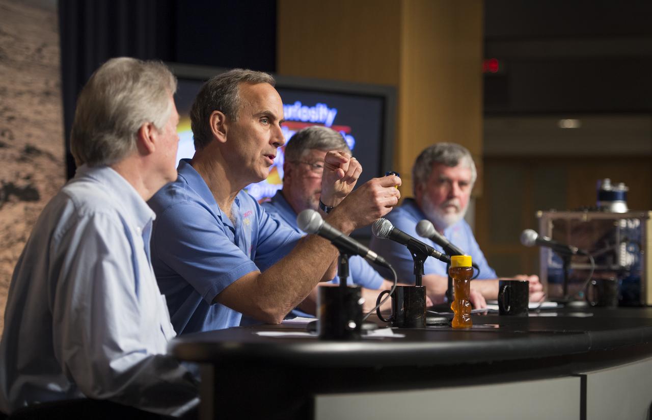 John Grotzinger (second from left), Curiosity project scientist, California Institute of Technology in Pasadena, speaks at a news conference presenting findings of the Curiosity rover's analysis of the first sample of rock powder collected on Mars, Tuesday, March 12, 2013 in Washington.  The rock sample collected shows ancient Mars could have supported living microbes.  Photo Credit:  (NASA/Carla Cioffi)