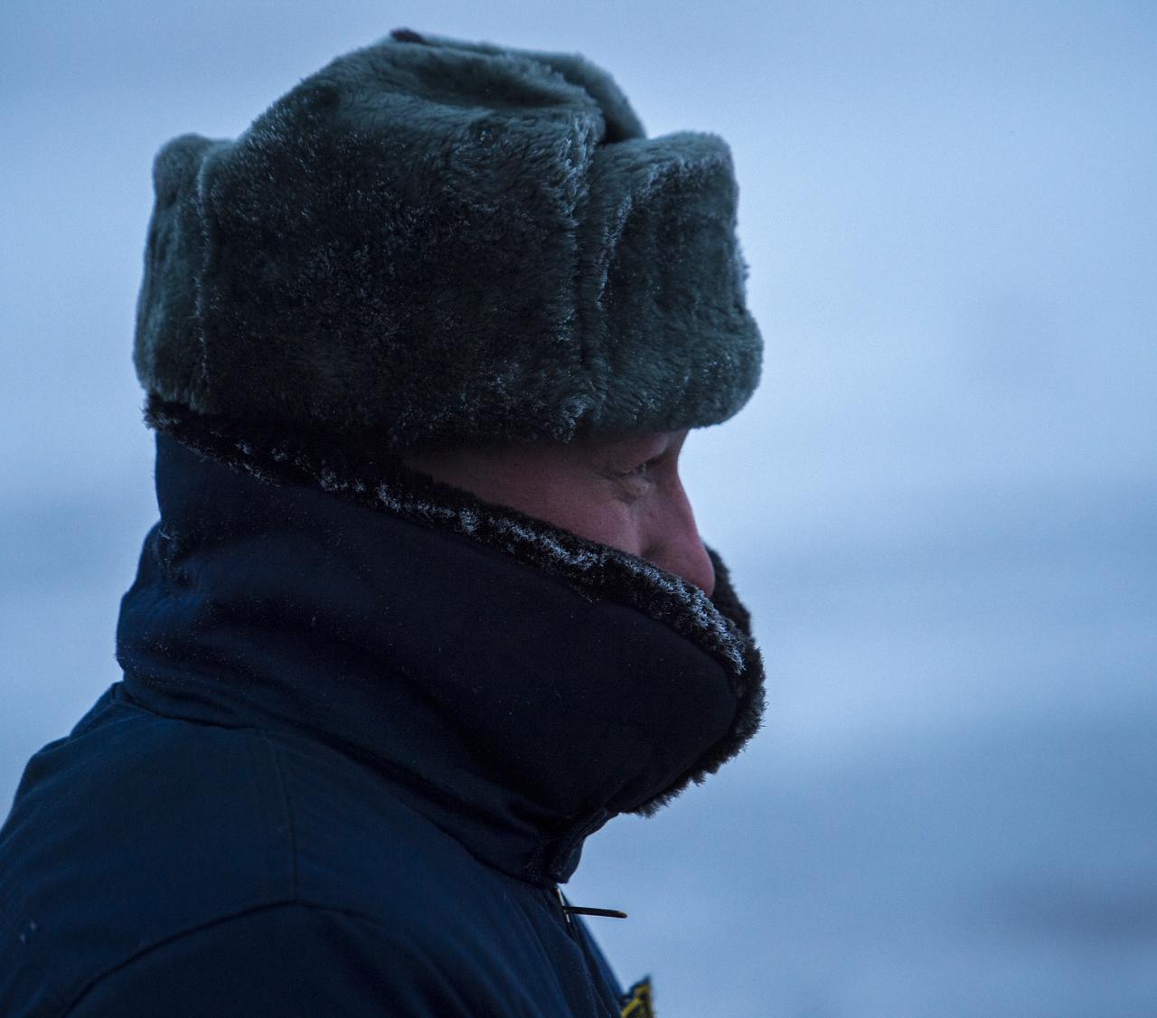 A helicopter crew member waits for weather to clear outside his Search and Rescue helicopter that was grounded by low visibility at the Arkalyk Airport in Kazakhstan on Saturday, March 16, 2013. The Soyuz TMA-06M spacecraft landed with Expedition 34 Commander Kevin Ford of NASA, Russian Soyuz Commander Oleg Novitskiy and Russian Flight Engineer Evgeny Tarelkin near the town of Arkalyk, Kazakhstan on Saturday, March 16, 2013. Ford, Novitskiy, and Tarelkin returned from 142 days onboard the International Space Station where they served as members of the Expedition 33 and 34 crews. Photo Credit: (NASA/Bill Ingalls)