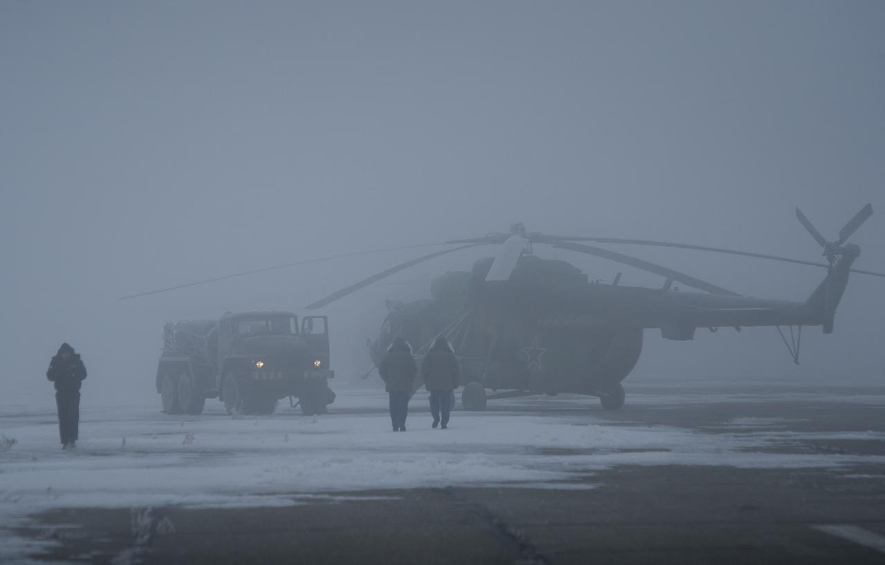 Search and Rescue helicopters are seen grounded by low visibility at the Arkalyk Airport in Kazakhstan on Saturday, March 16, 2013. The Soyuz TMA-06M spacecraft landed with Expedition 34 Commander Kevin Ford of NASA, Russian Soyuz Commander Oleg Novitskiy and Russian Flight Engineer Evgeny Tarelkin near the town of Arkalyk, Kazakhstan on Saturday, March 16, 2013. Ford, Novitskiy, and Tarelkin returned from 142 days onboard the International Space Station where they served as members of the Expedition 33 and 34 crews. Photo Credit: (NASA/Bill Ingalls)
