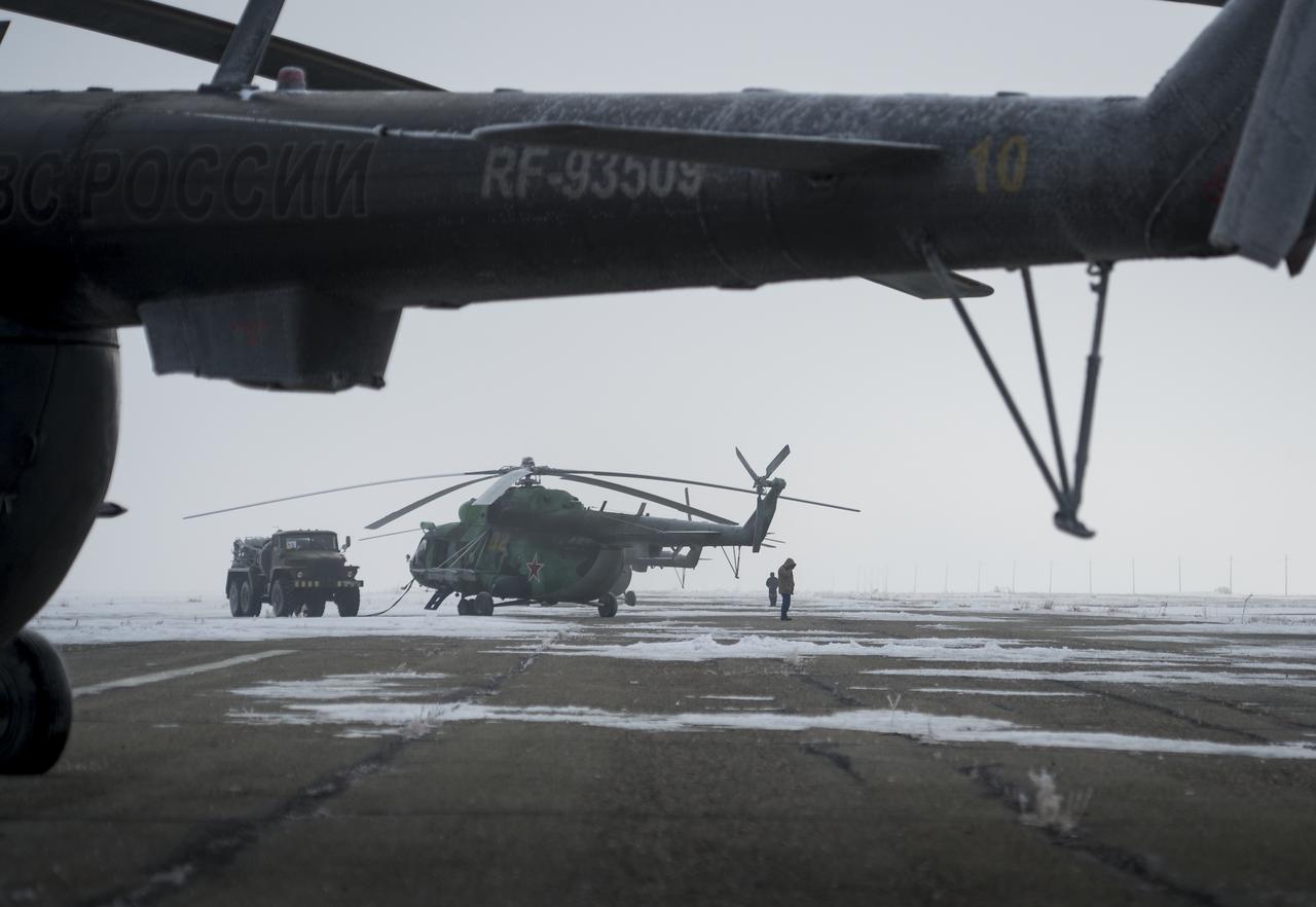 Search and Rescue helicopters are seen grounded by low visibility at the Arkalyk Airport in Kazakhstan on Saturday, March 16, 2013. The Soyuz TMA-06M spacecraft landed with Expedition 34 Commander Kevin Ford of NASA, Russian Soyuz Commander Oleg Novitskiy and Russian Flight Engineer Evgeny Tarelkin near the town of Arkalyk, Kazakhstan on Saturday, March 16, 2013. Ford, Novitskiy, and Tarelkin returned from 142 days onboard the International Space Station where they served as members of the Expedition 33 and 34 crews. Photo Credit: (NASA/Bill Ingalls)