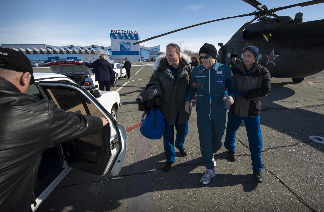 Expedition 34 Commander Kevin Ford of NASA walks from a Russian Search and Rescue helicopter with NASA flight doctors, David Alexander, left, and Blake Chamberlain after flying from his Soyuz TMA-06M spacecraft landing site outside the town of Arkalyk to Kustanay, Kazakhstan on Saturday, March 16, 2013. Ford, along with Russian Soyuz Commander Oleg Novitskiy and Flight Engineer Evgeny Tarelkin of Russia returned from 142 days onboard the International Space Station where they served as members of the Expedition 33 and 34 crews. Photo Credit: (NASA/Bill Ingalls)