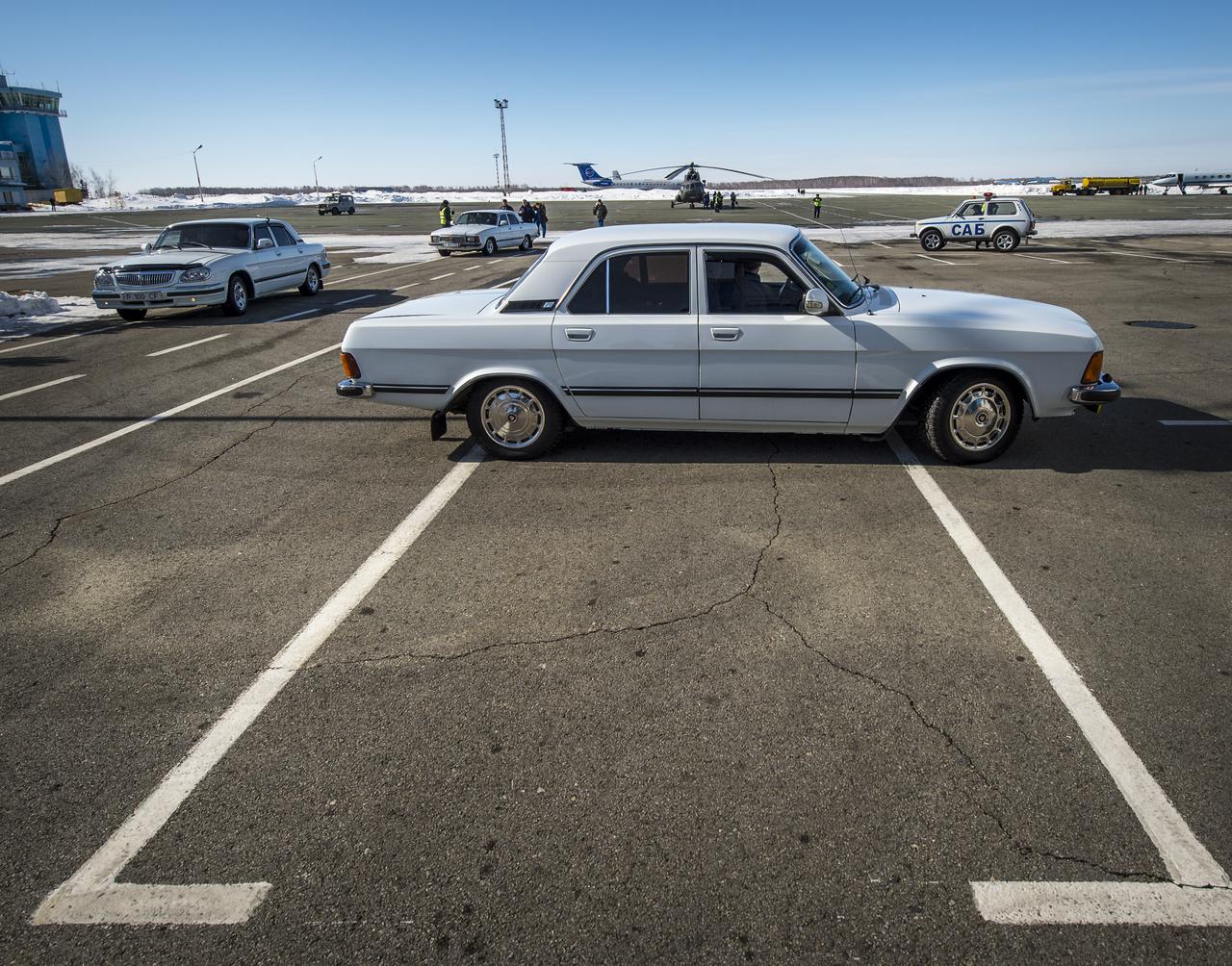 Cars carrying Expedition 34 Commander Kevin Ford of NASA, Russian Soyuz Commander Oleg Novitskiy and Russian Flight Engineer Evgeny Tarelkin pull up to the terminal at the Kustanay Airport a few hours after the crew landed their Soyuz TMA-06M spacecraft near the town of Arkalyk, Kazakhstan on Saturday, March 16, 2013. Ford, Novitskiy, and, Tarelkin returned from 142 days onboard the International Space Station where they served as members of the Expedition 33 and 34 crews. Photo Credit: (NASA/Bill Ingalls)