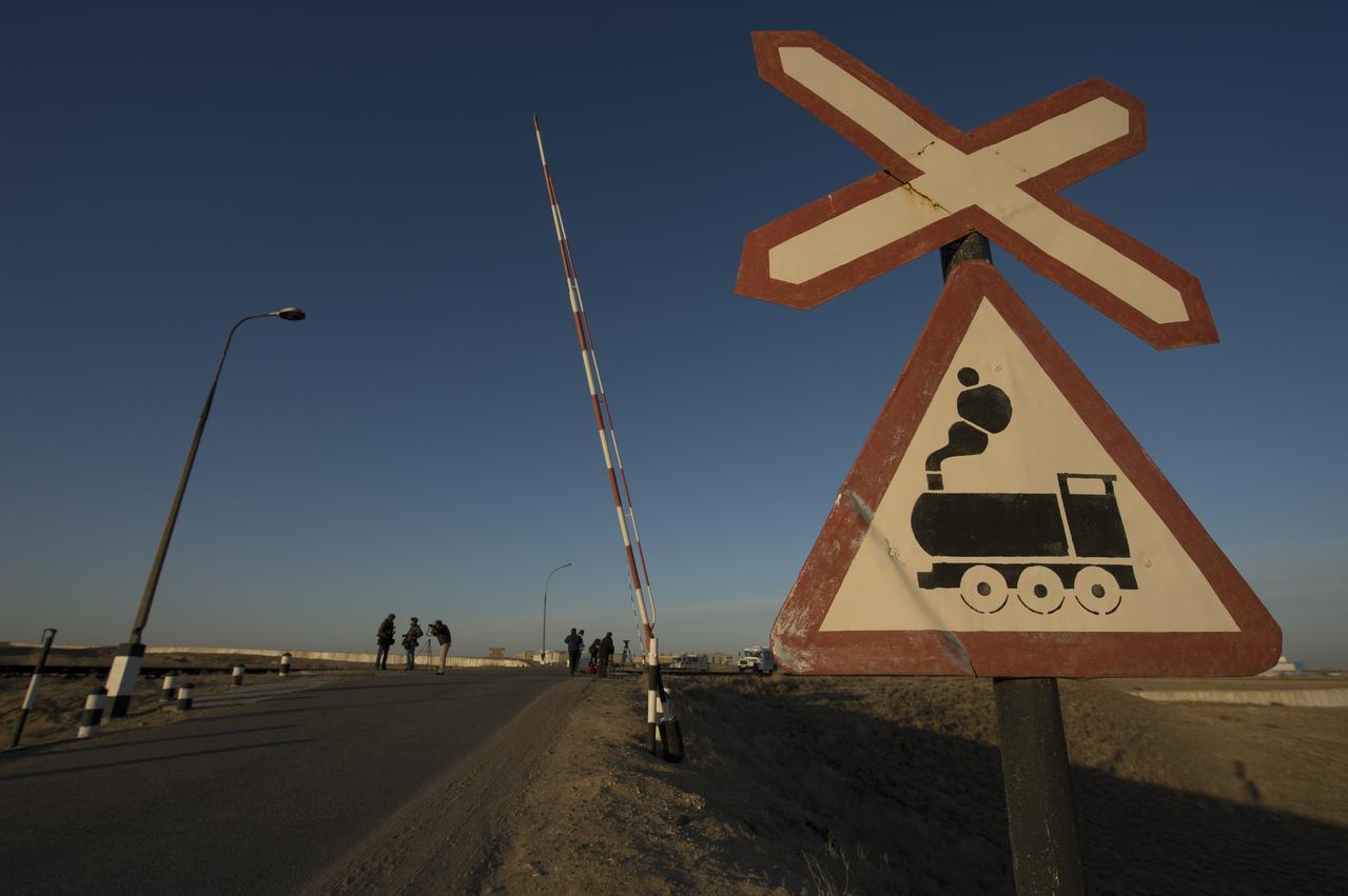 A railroad crossing sign is seen in front of the train tracks on which the Soyuz rocket is rolled out to its launch pad, Tuesday, March 26, 2013 at the Baikonur Cosmodrome in Kazakhstan. Launch of the Soyuz rocket is scheduled for March 29 and will send Expedition 35 Soyuz Commander Pavel Vinogradov, and Flight Engineers Chris Cassidy of NASA and Alexander Misurkin of Russia on a five and a half-month mission aboard the International Space Station. Photo Credit: (NASA/Carla Cioffi)
