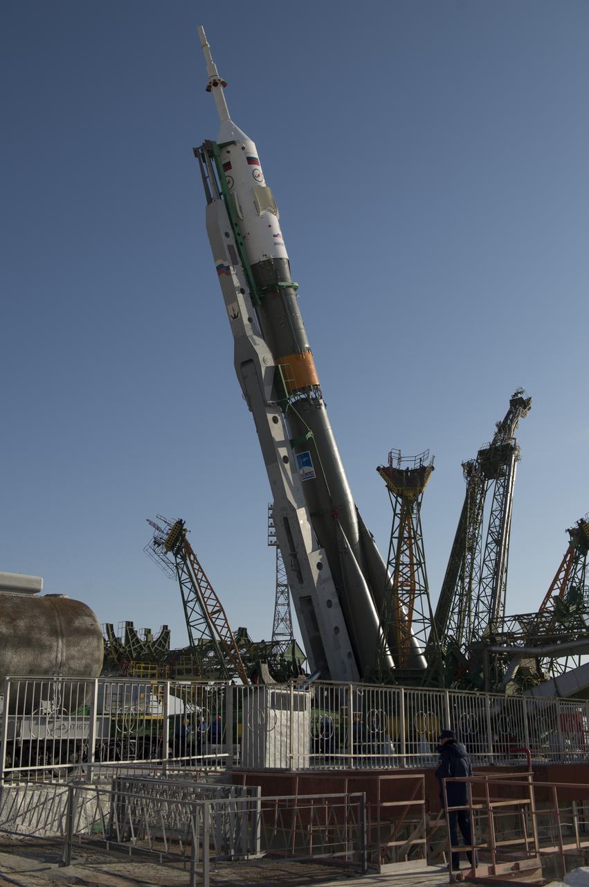 The Soyuz rocket is erected into position after being rolled out to the launch pad by train on Tuesday, March 26, 2013, at the Baikonur Cosmodrome in Kazakhstan. Launch of the Soyuz rocket is scheduled for March 29 and will send Expedition 35 Soyuz Commander Pavel Vinogradov, and Flight Engineers Chris Cassidy of NASA and Alexander Misurkin of Russia on a five and a half-month mission aboard the International Space Station. Photo Credit: (NASA/Carla Cioffi)
