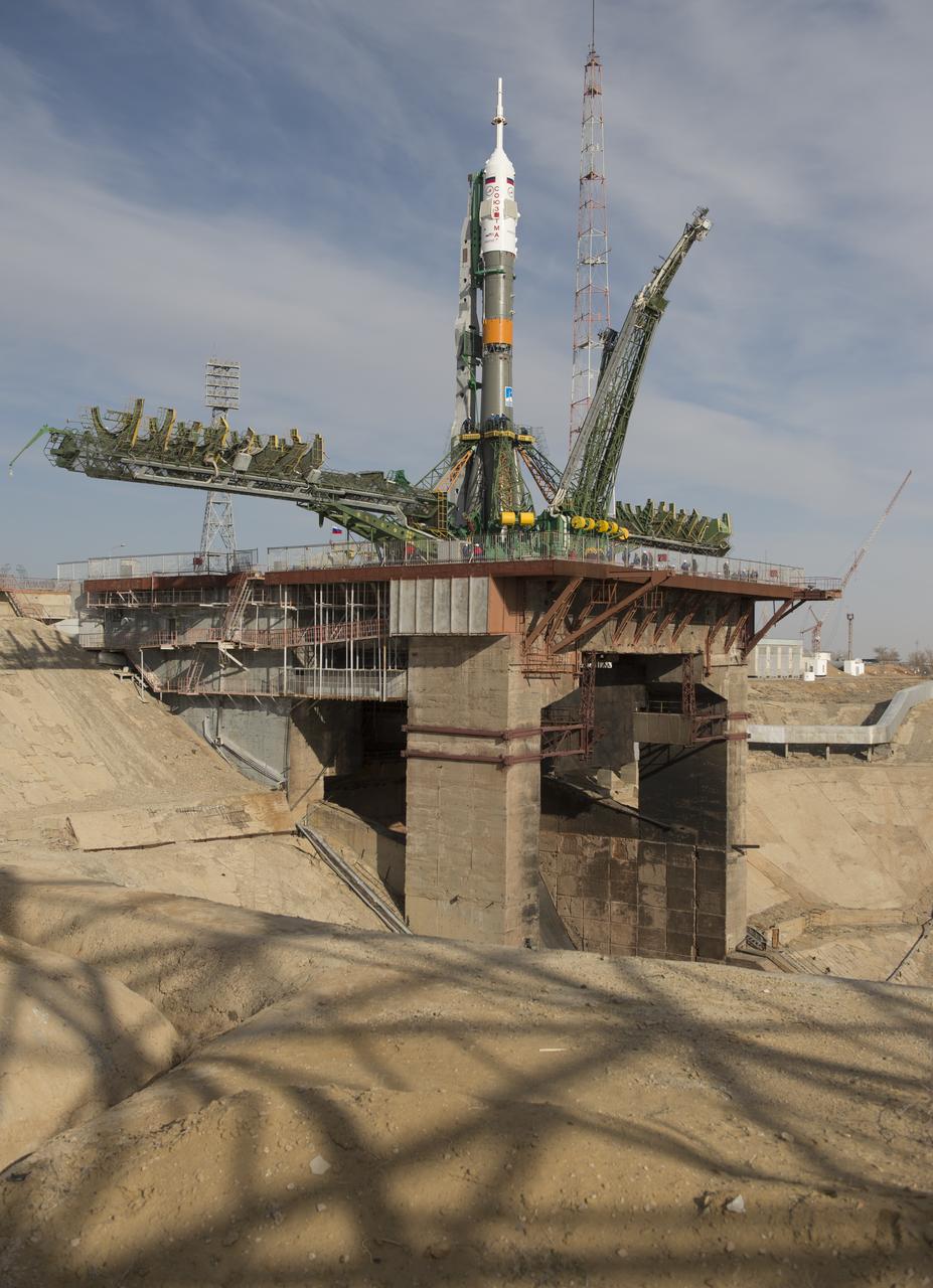The Soyuz rocket is seen on its launch pad shortly after being lifted into its upright position on Tuesday March 26, 2013, at the Baikonur Cosmodrome in Kazakhstan. Launch of the Soyuz rocket is scheduled for March 29 and will send Expedition 35 Soyuz Commander Pavel Vinogradov, and Flight Engineers Chris Cassidy of NASA and Alexander Misurkin of Russia on a five and a half-month mission aboard the International Space Station. Photo Credit: (NASA/Carla Cioffi)