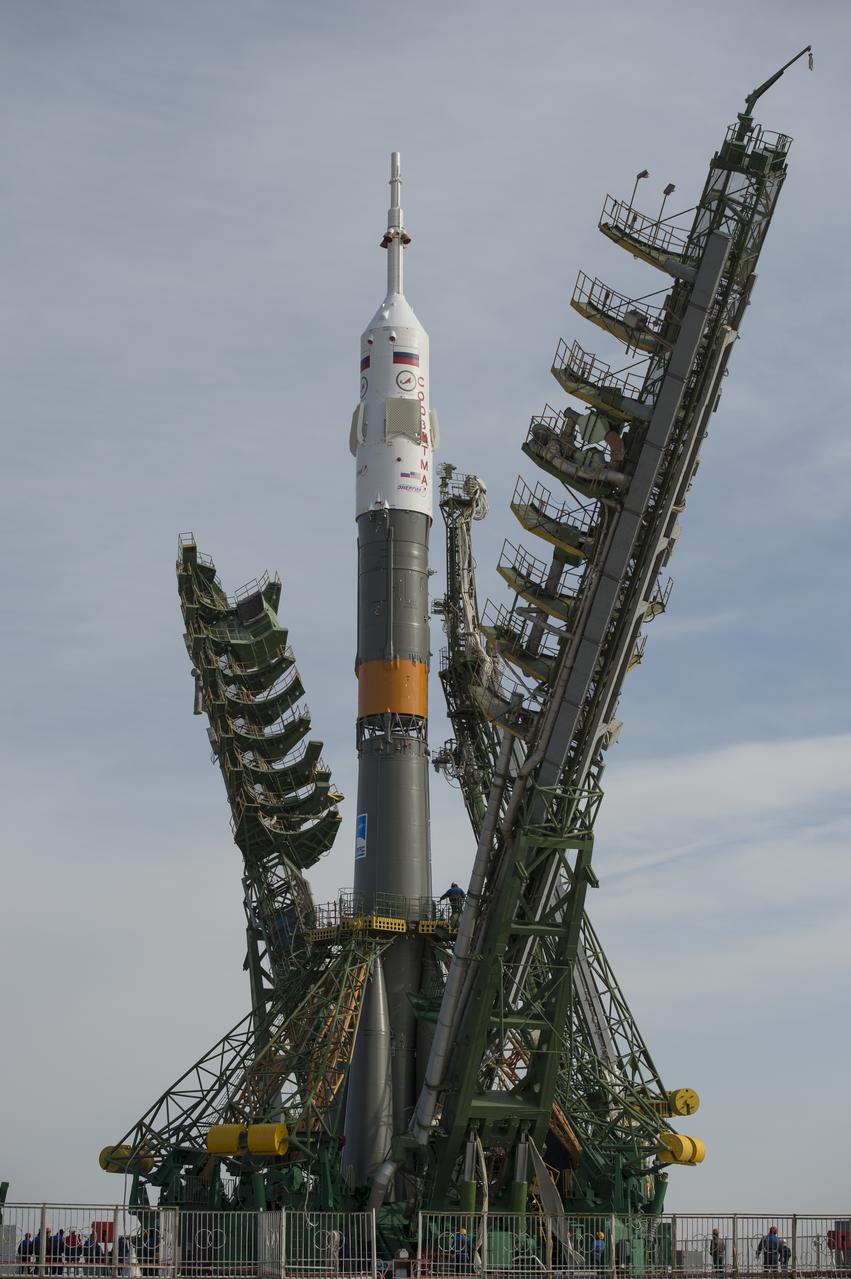Large gantry mechanisms on either side of the Soyuz TMA-08M spacecraft are raised into position to secure the rocket at the launch pad on Tuesday, March 26, 2013 at the Baikonur Cosmodrome in Kazakhstan. Launch of the Soyuz rocket is scheduled for March 29 and will send Expedition 35 Soyuz Commander Pavel Vinogradov, and Flight Engineers Chris Cassidy of NASA and Alexander Misurkin of Russia on a five and a half-month mission aboard the International Space Station. Photo Credit: (NASA/Carla Cioffi)