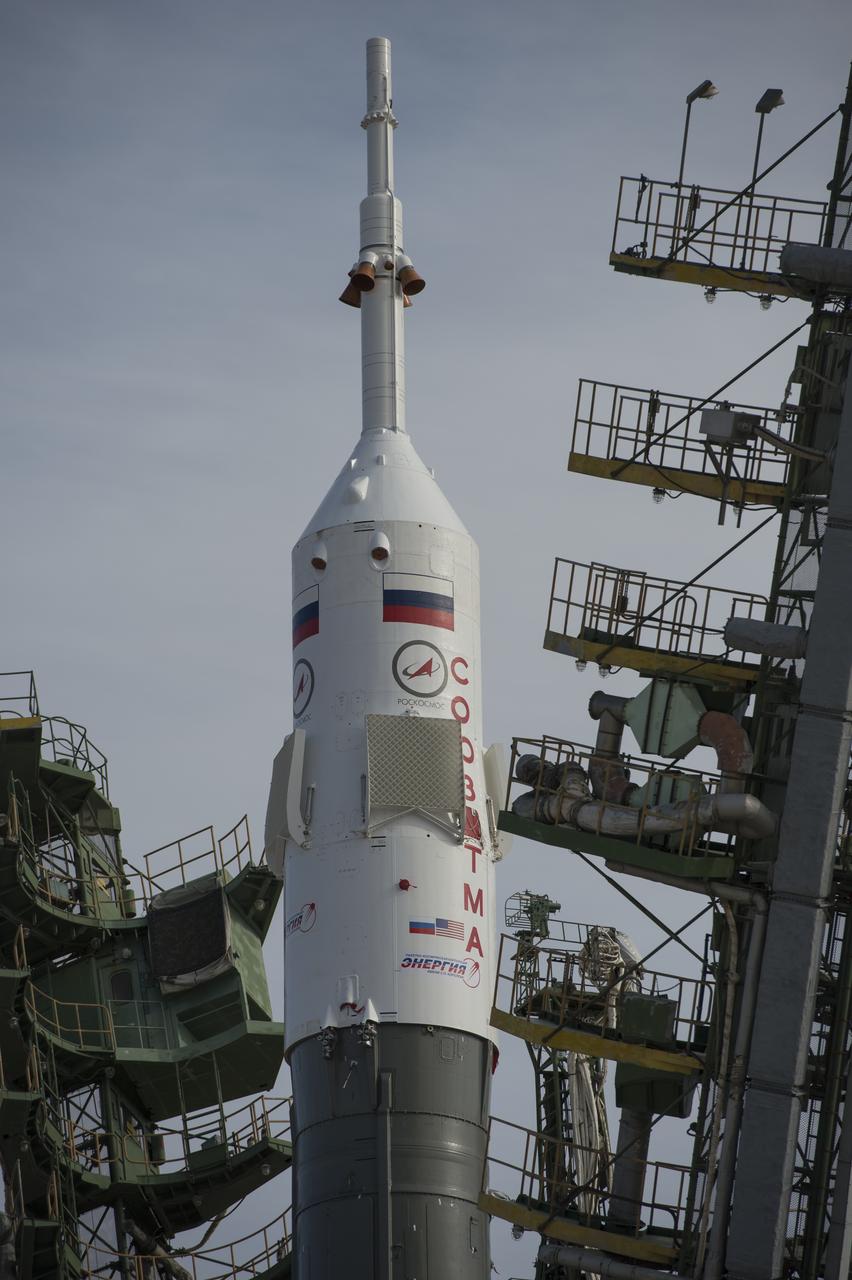 Large gantry mechanisms on either side of the Soyuz TMA-08M spacecraft are raised into position to secure the rocket at the launch pad on Tuesday, March 26, 2013 at the Baikonur Cosmodrome in Kazakhstan. Launch of the Soyuz rocket is scheduled for March 29 and will send Expedition 35 Soyuz Commander Pavel Vinogradov, and Flight Engineers Chris Cassidy of NASA and Alexander Misurkin of Russia on a five and a half-month mission aboard the International Space Station. Photo Credit: (NASA/Carla Cioffi)