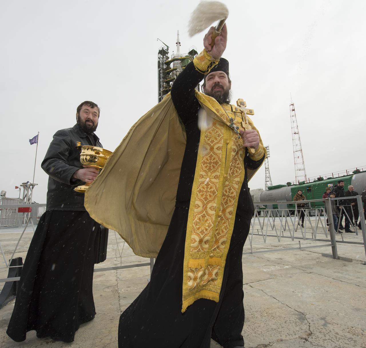 An Orthodox priest blesses members of the media shortly after blessing the Soyuz rocket at the Baikonur Cosmodrome launch pad on Wednesday, March 27, 2013 in Kazakhstan. Launch of the Soyuz rocket is scheduled for March 29 and will send Expedition 35 Soyuz Commander Pavel Vinogradov, and Flight Engineers Chris Cassidy of NASA and Alexander Misurkin of Russia on a five and a half-month mission aboard the International Space Station. Photo Credit: (NASA/Carla Cioffi)