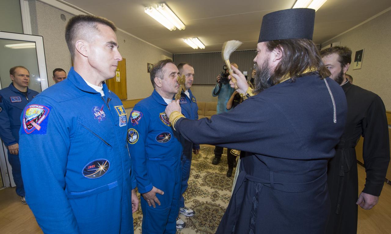 Expedition 35 Soyuz Commander Pavel Vinogradov, second from left, receives the traditional blessing from a Russian Orthodox priest at the Cosmonaut Hotel prior to his launch on the Soyuz rocket to the International Space Station, Thursday, March 28, 2013, in Baikonur, Kazakhstan. Vinogradov, NASA Flight Engineer Chris Cassidy and Russian Flight Engineer Alexander Misurkin will spend five and a half-months living and working aboard the ISS. Photo Credit: (NASA/Carla Cioffi)