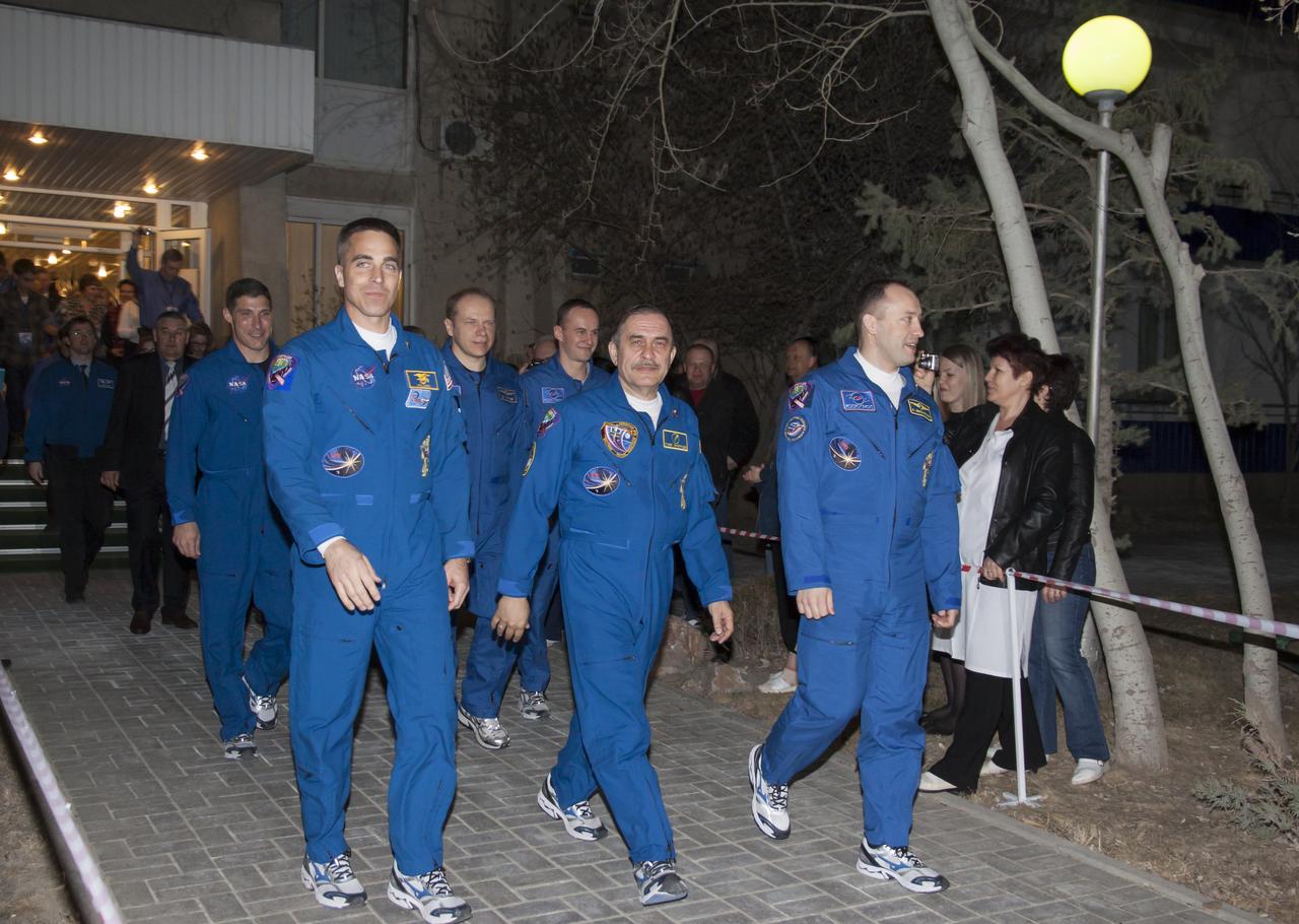 Expedition 35 crew members NASA Flight Engineer Chris Cassidy, left, Soyuz Commander Pavel Vinogradov and Russian Flight Alexander Misurkin, right, depart the Cosmonaut Hotel to suit-up for their soyuz launch to the International Space Station, Thursday, March 28, 2013, in Baikonur, Kazakhstan. Launch of the Soyuz rocket will send Cassidy, Vinogradov and Misurkin on a five and a half month mission aboard the International Space Station. Photo Credit: (NASA/Victor Zelentsov)