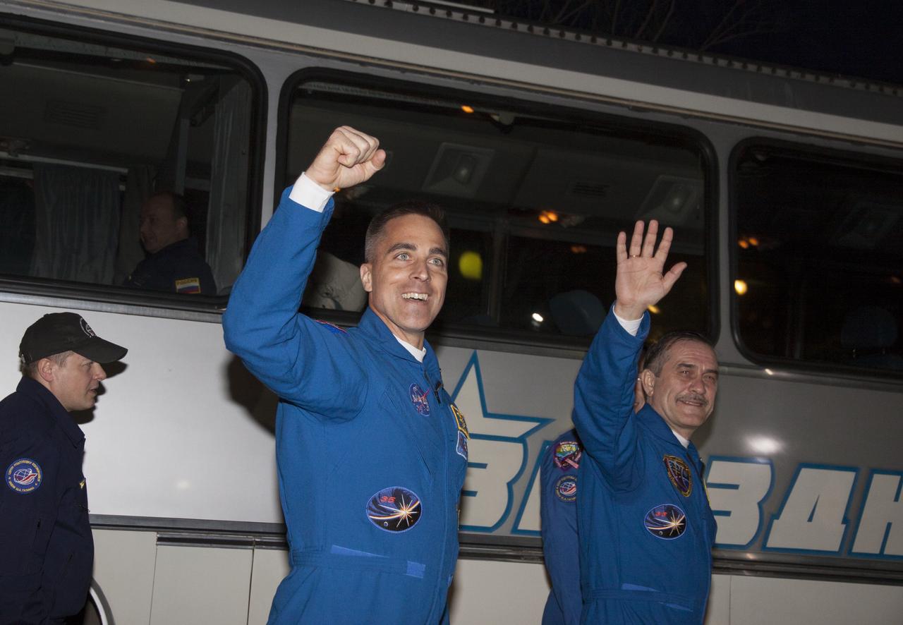 Expedition 35 crew members NASA Flight Engineer Chris Cassidy, left, and Soyuz Commander Pavel Vinogradov wave farewell to family and friends as they depart the Cosmonaut Hotel to suit-up for their soyuz launch to the International Space Station, Thursday, March 28, 2013, in Baikonur, Kazakhstan. Launch of the Soyuz rocket will send Cassidy, Vinogradov and Misurkin on a five and a half month mission aboard the International Space Station.   Photo Credit: (NASA/Victor Zelentsov)