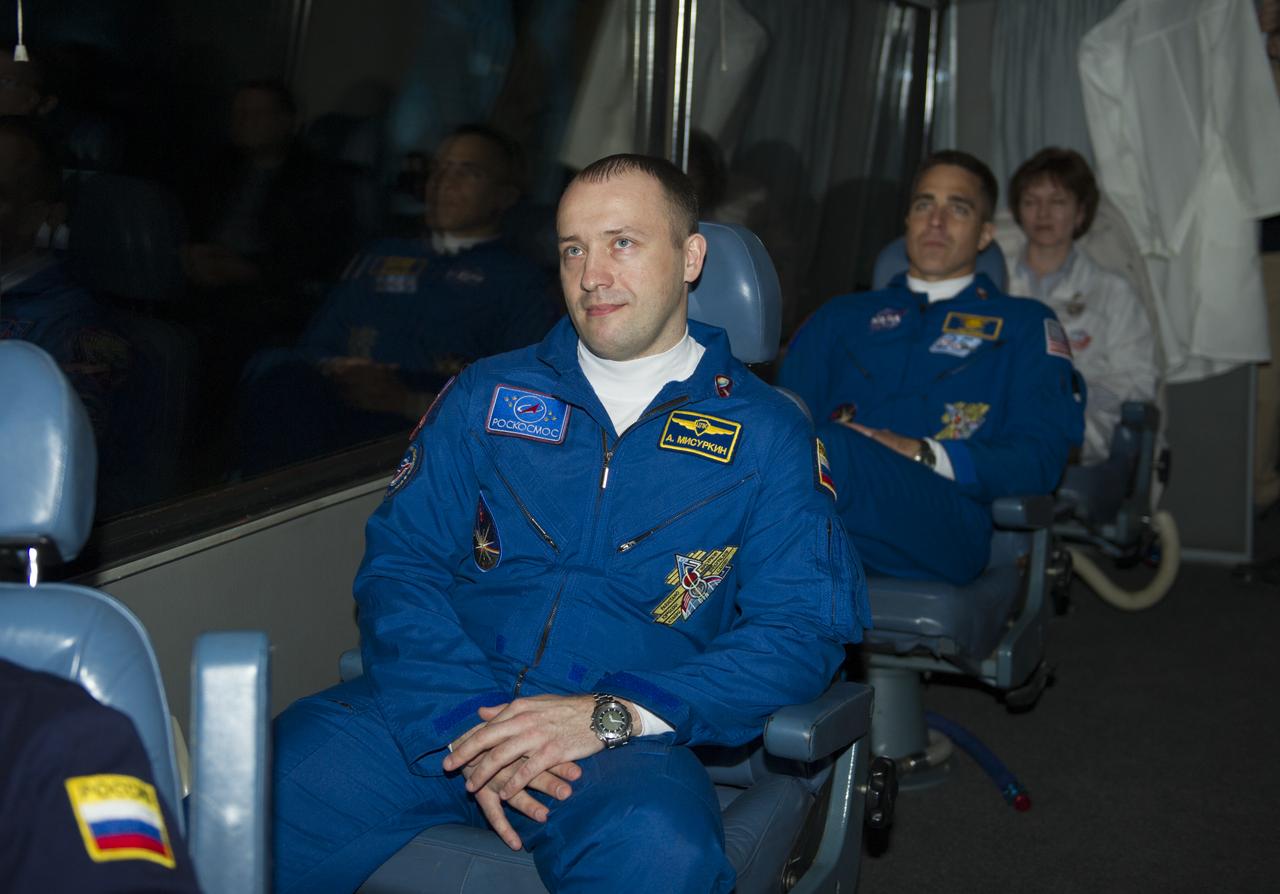 Expedition 35 Flight Engineers Alexander Misurkin, foreground, and Chris Cassidy watch a video as the crew bus departs the Cosmonaut Hotel on Thursday, March 28, 2013 in Baikonur, Kazakhstan. The launch of the Soyuz spacecraft with Misurkin, Cassidy and Soyuz Commander Pavel Vinogradov launched at 2:43 a.m. local time on March 29. Photo Credit: (NASA/GCTC/Irina Peshkova)