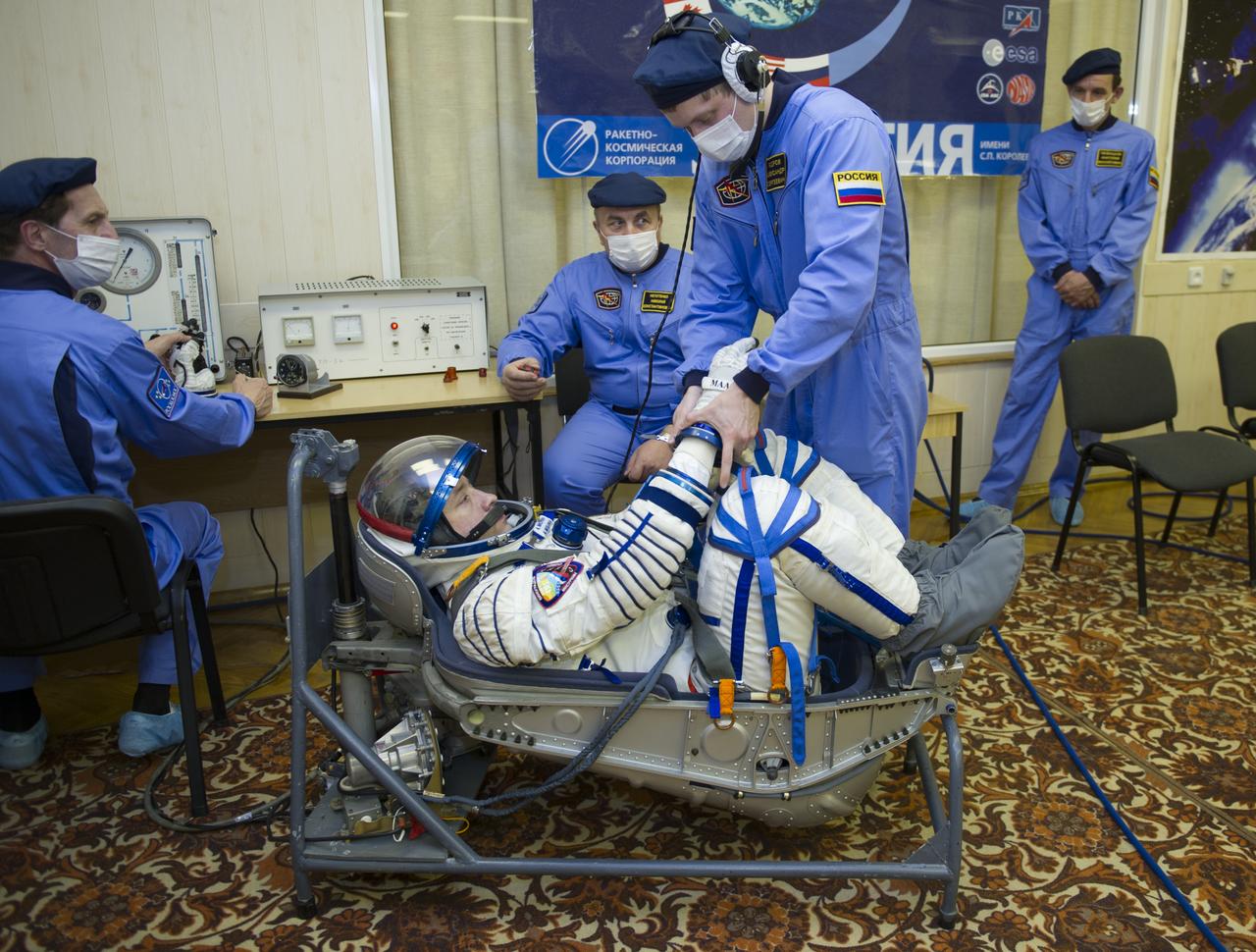 Expedition 35 Russian Flight Engineer Alexander Misurkin has his Russian Sokol suit pressure checked ahead of his launch onboard a Soyuz TMA-08M spacecraft to the International Space Station, Thursday, March 28, 2013, at the Baikonur Cosmodrome in Kazakhstan. Launch of the Soyuz rocket will send Misurkin, Soyuz Commander Pavel Vinogradov and NASA Flight Engineer Chris Cassidy on a five and a half-month mission aboard the International Space Station. Photo Credit: (NASA/GCTC/Irina Peshkova)