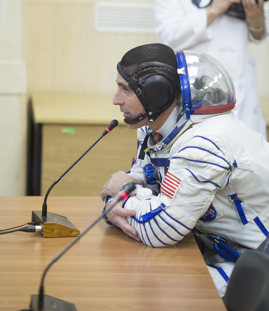 Expedition 35 Flight Engineer Chris Cassidy is seen talking to family members after donning his Russian Sokol suit in preparation for his launch aboard the Soyuz rocket, Thursday, March 28, 2013, at the Baikonur Cosmodrome in Kazakhstan. Launch of the Soyuz rocket will send Cassidy, Soyuz Commander Pavel Vinogradov and Russian Flight Engineer Alexander Misurkin on a five and a half-month mission aboard the International Space Station. Photo Credit: (NASA/Carla Cioffi)