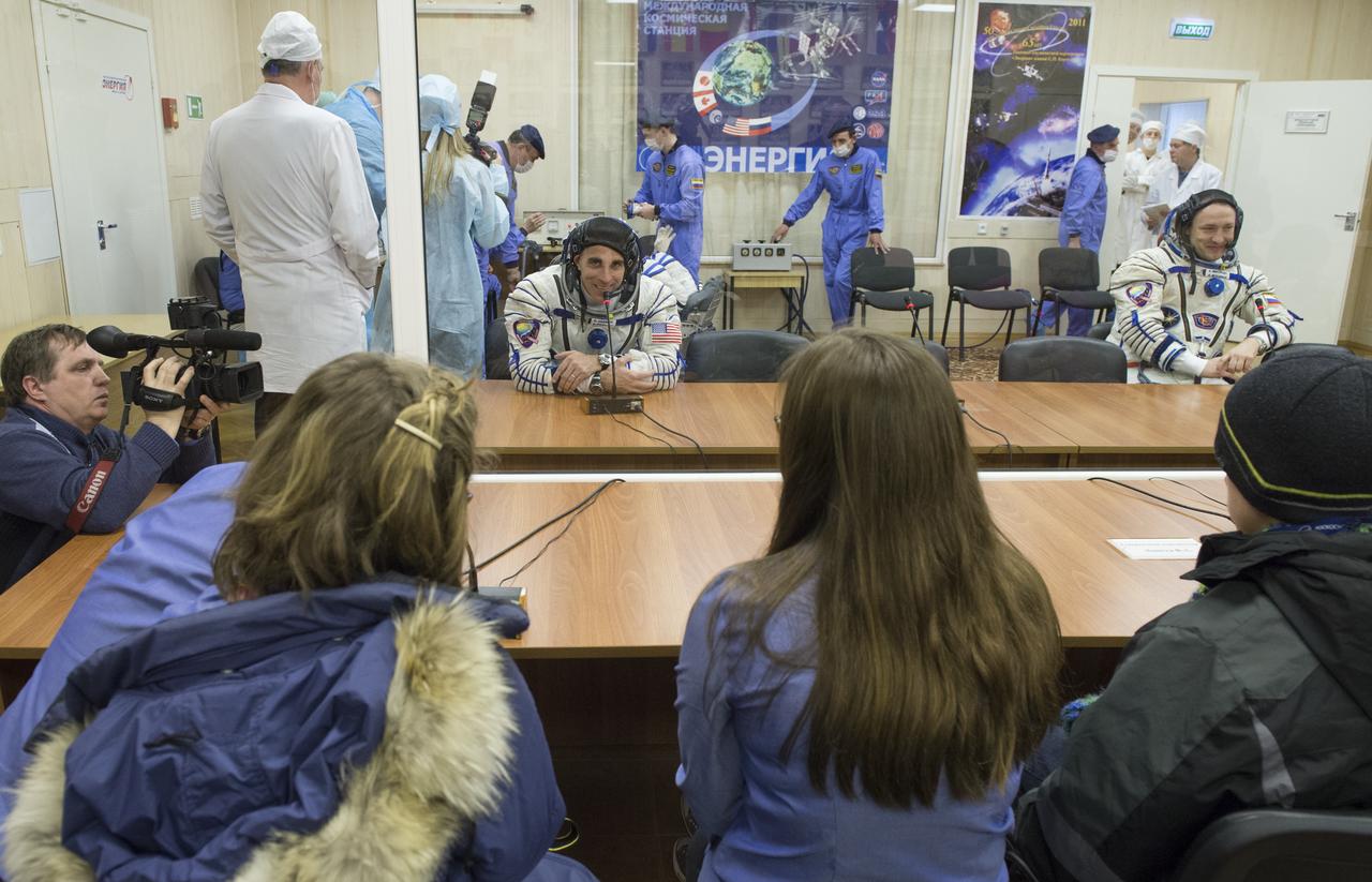 Expedition 35 Flight Engineer Chris Cassidy is seen talking to family members after donning his Russian Sokol suit in preparation for his launch aboard the Soyuz rocket, Thursday, March 28, 2013, at the Baikonur Cosmodrome in Kazakhstan. Launch of the Soyuz rocket will send Cassidy, Soyuz Commander Pavel Vinogradov and Russian Flight Engineer Alexander Misurkin on a five and a half-month mission aboard the International Space Station. Photo Credit: (NASA/Carla Cioffi)