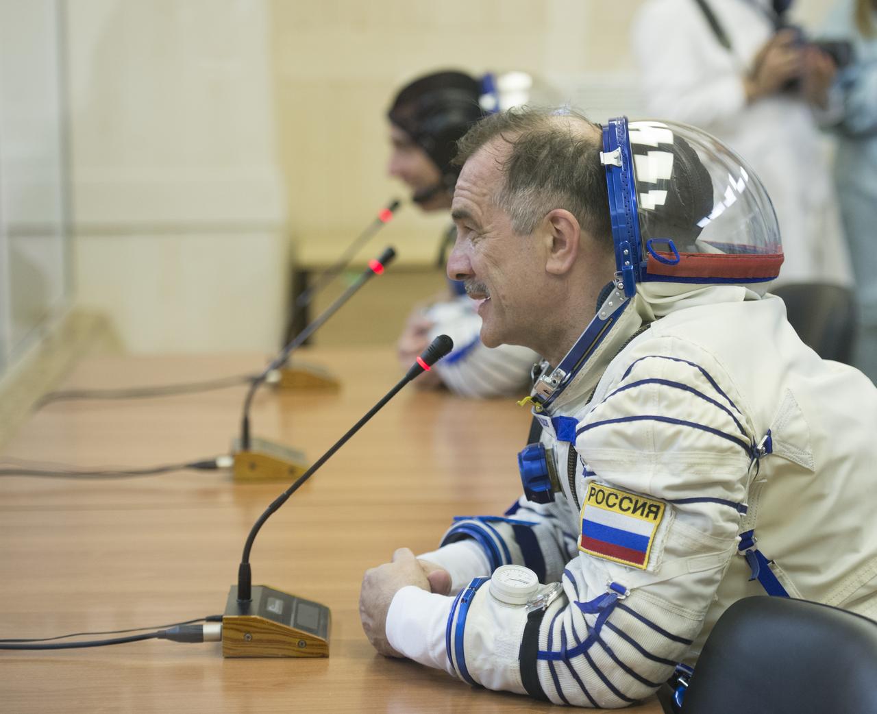 Expedition 35 Soyuz Commander Pavel Vinogradov is seen talking to family members after donning his Russian Sokol suit in preparation for his launch aboard the Soyuz rocket, Thursday, March 28, 2013, at the Baikonur Cosmodrome in Kazakhstan.  Launch of the Soyuz rocket will send Vinogradov, Flight Engineer Chris Cassidy and Russian Flight Engineer Alexander Misurkin on a five and a half-month mission aboard the International Space Station.  Photo Credit: (NASA/Carla Cioffi)