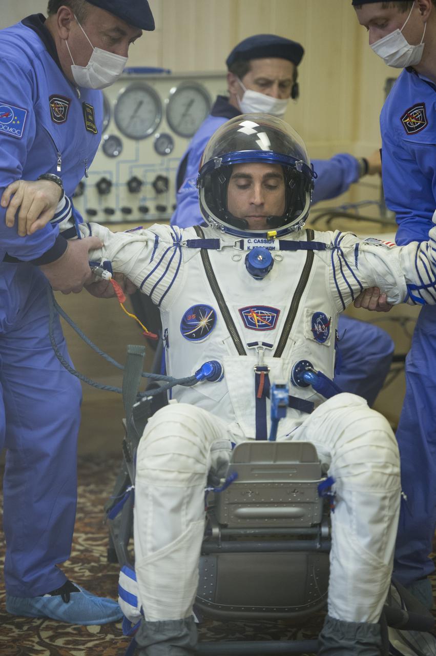Expedition 35 NASA Flight Engineer Chris Cassidy is lifted out of his chair after having had his Russian Sokol suit pressure checked ahead of his launch onboard a Soyuz TMA-08M spacecraft to the International Space Station, Thursday, March 28, 2013, at the Baikonur Cosmodrome in Kazakhstan.  Launch of the Soyuz rocket will send Cassidy, Soyuz Commander Pavel Vinogradov and Russian Flight Engineer Alexander Misurkin on a five and a half-month mission aboard the International Space Station.  Photo Credit: (NASA/Carla Cioffi)