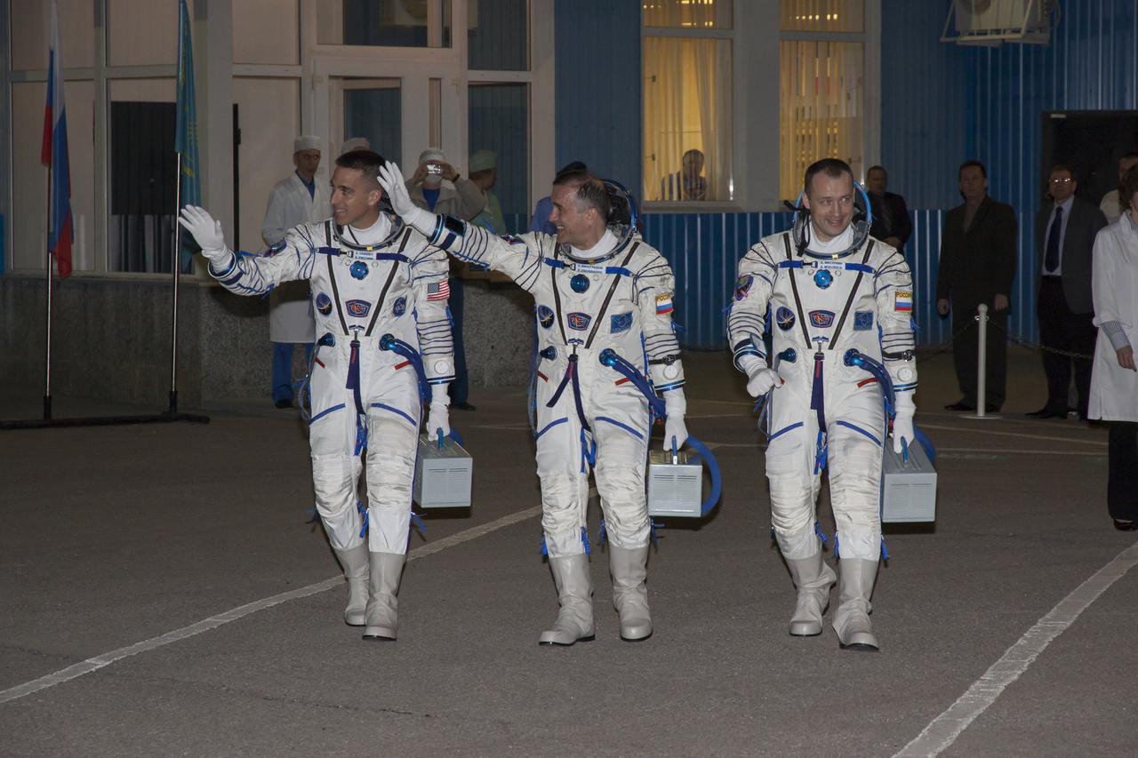 Expedition 35 crew members NASA Flight Engineer Chris Cassidy, left, Soyuz Commander Pavel Vinogradov and Russian Flight Engineer Alexander Misurkin, right, walk out of building 254 of the Baikonur Cosmodrome to board a bus that will take them to the launch pad for their launch onboard a Soyuz TMA-08M spacecraft to the International Space Station, Thursday, March 28, 2013, in Baikonur, Kazakhstan. Launch of the Soyuz rocket will send Cassidy, Vinogradov and Misurkin on a five and a half month mission aboard the International Space Station. Photo Credit: (NASA/Victor Zelentsov)