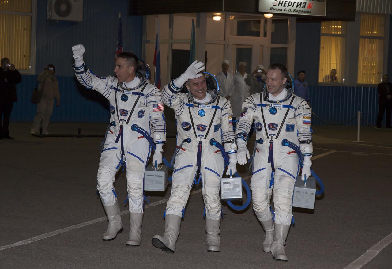 Expedition 35 crew members NASA Flight Engineer Chris Cassidy, left, Soyuz Commander Pavel Vinogradov and Russian Flight Engineer Alexander Misurkin, right, walk out of building 254 of the Baikonur Cosmodrome to board a bus that will take them to the launch pad for their launch onboard a Soyuz TMA-08M spacecraft to the International Space Station, Thursday, March 28, 2013, in Baikonur, Kazakhstan. Launch of the Soyuz rocket will send Cassidy, Vinogradov and Misurkin on a five and a half month mission aboard the International Space Station. Photo Credit: (NASA/Victor Zelentsov)