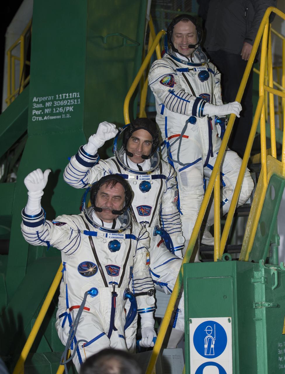 Expedition 35 Russian Flight Engineer Alexander Misurkin, top, NASA Flight Engineer Chris Cassidy, and Soyuz Commander Pavel Vinogradov, bottom, wave farewell from the base of the Soyuz rocket at the Baikonur Cosmodrome in Baikonur, Kazakhstan, Friday, March 29, 2013. Their Soyuz TMA-08M rocket launched at 2:43 a.m. local time. Photo Credit: (NASA/Carla Cioffi)