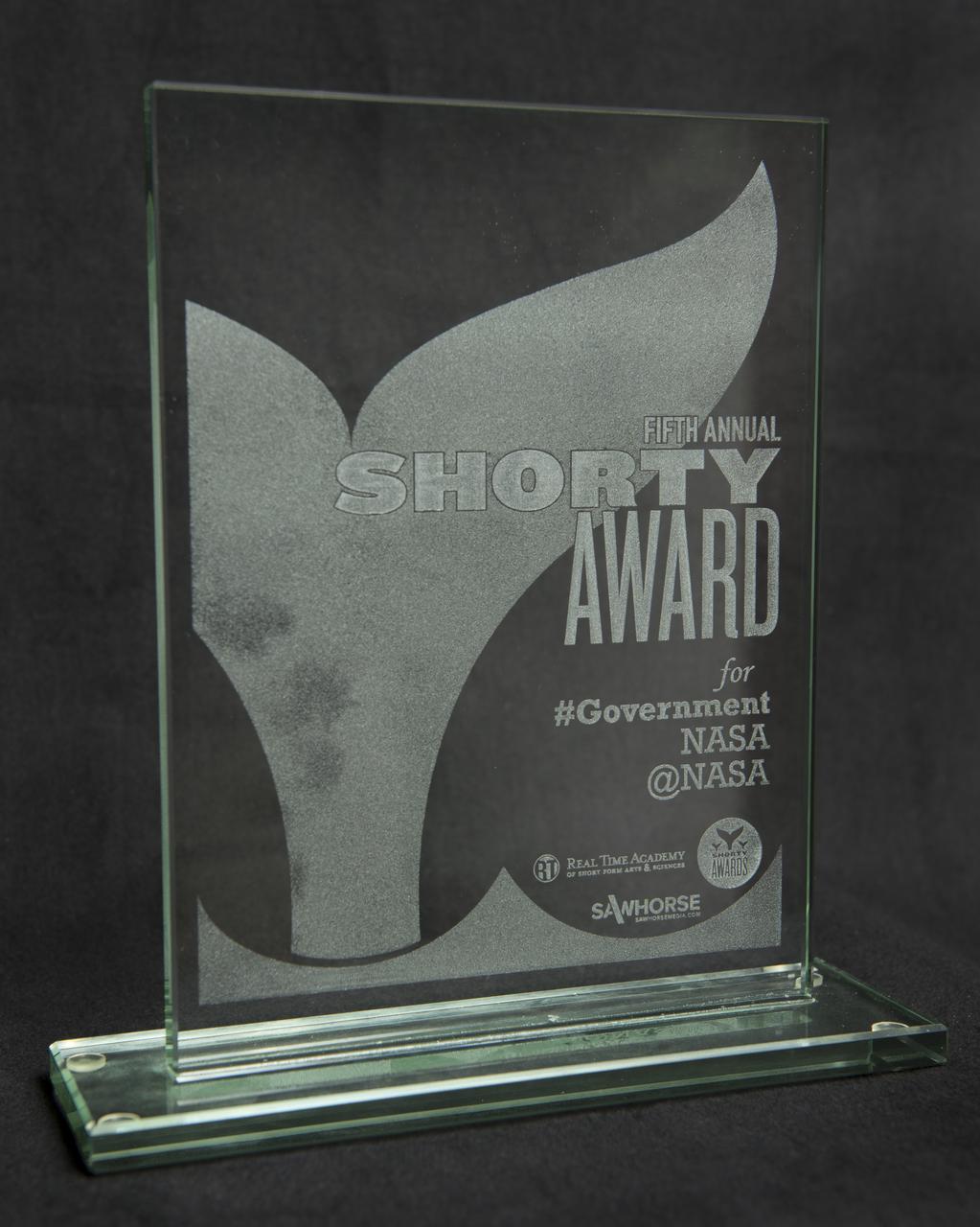 A Shorty Award is seen Wednesday, April 10, 2013 at NASA Headquarters in Washington. NASA's official Twitter feed, @NASA, has won its second consecutive Shorty award for the best government use of social media.  The Shorty Award honors the best of social media across sites such as Twitter, Facebook, Tumblr, YouTube, Foursquare and others.  NASA took the prize Monday, April 8, at the fifth Shorty Awards ceremony in New York.  The @NASA acceptance tweet was, "We're sharing the universe 1 tweet at a time.  Be inspired!  Follow @NASA & RT if you love science & space.  #ShortyAwards."  Photo Credit:  (NASA/Carla Cioffi)