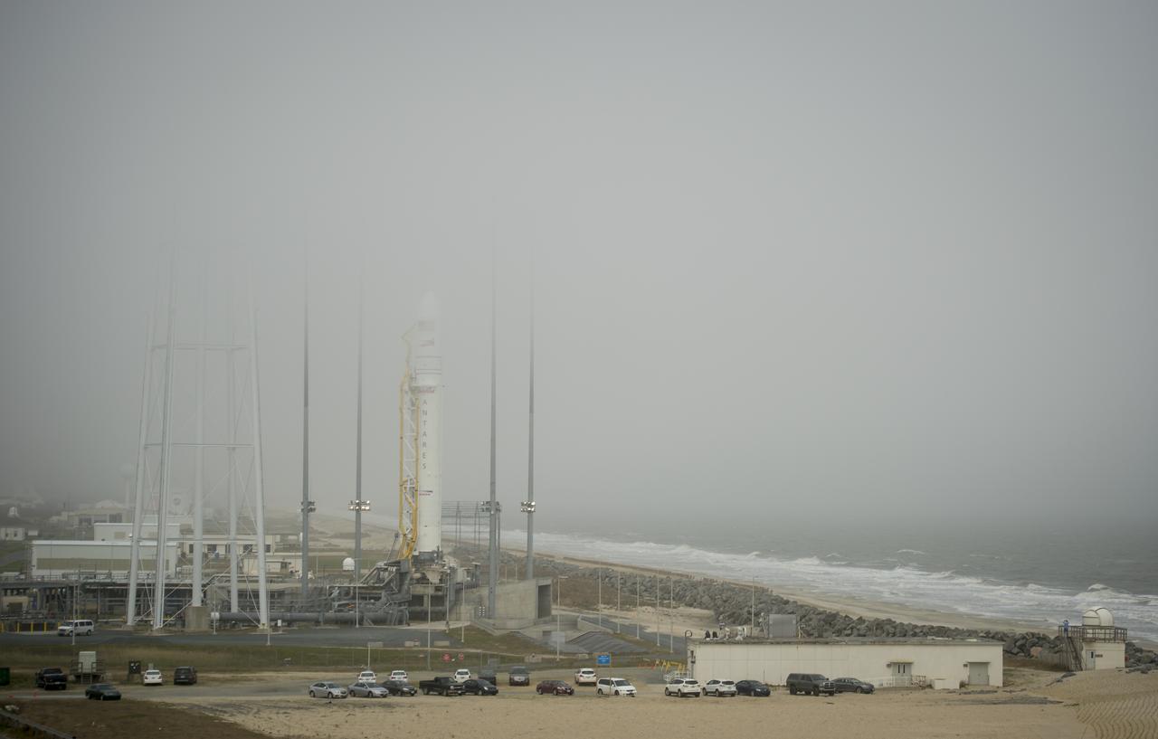 Fog rolls in as the Orbital Sciences Corporation Antares rocket is seen on the Mid-Atlantic Regional Spaceport (MARS) Pad-0A at the NASA Wallops Flight Facility, Friday, April 19, 2013 in Virginia.  NASA's commercial space partner, Orbital Sciences Corporation, is scheduled to test launch its first Antares on Saturday, April 20, 2013.  Photo Credit: (NASA/Bill Ingalls)