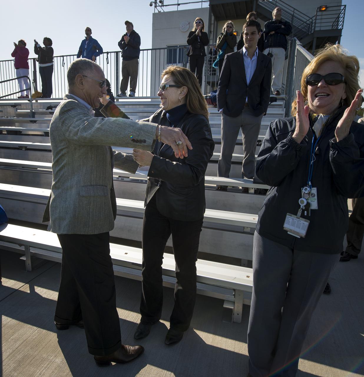 NASA Administrator Charles Bolden and NASA Deputy Administrator Lori Garver and other guests react after having watched the successful launch of the Orbital Sciences Corporation Antares rocket from the Mid-Atlantic Regional Spaceport (MARS) at the NASA Wallops Flight Facility in Virginia, Sunday, April 21, 2013. The test launch marked the first flight of Antares and the first rocket launch from Pad-0A. The Antares rocket delivered the equivalent mass of a spacecraft, a so-called mass simulated payload, into Earth's orbit. Photo Credit: (NASA/Bill Ingalls)