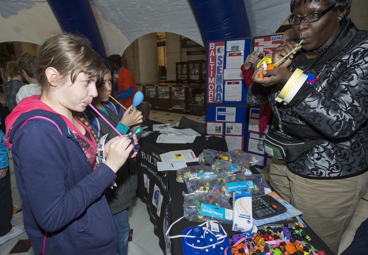 Students assemble balloon race cars and Alka-Seltzer film canister rockets to demonstrate Newton's third Law of motion at the NASA Science Gallery at Union Station, Monday, April 22, 2013 in Washington. The NASA Science Gallery exhibits are being sponsored by  NASA in honor of Earth Day. (Photo Credit:  NASA/Carla Cioffi)