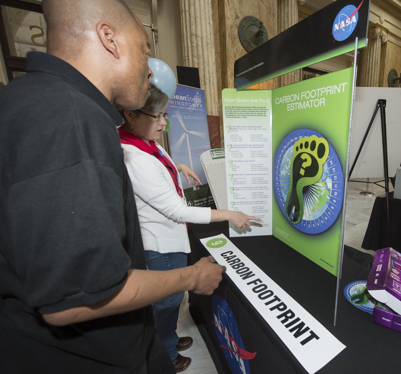 A participant at NASA's Earth Day Science Gallery Exhibit calculates his carbon footprint at the Carbon Footprint Estimator, Monday, April 22, 2013 at Union Station in Washington.  The NASA Science Gallery exhibits are being sponsored by  NASA in honor of Earth Day. (Photo Credit:  NASA/Carla Cioffi)