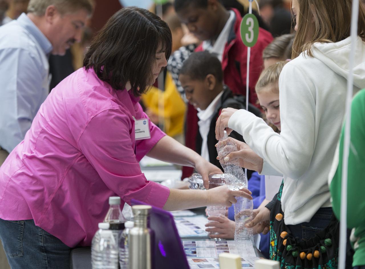 Izolda Trakhtenberg, Science Educator at NASA Goddard Spaceflight Center, conducts an experiment with students to create a cloud in a bottle, Monday, April 22, 2013 at Union Station in Washington.  The NASA Science Gallery exhibits are being sponsored by NASA in honor of Earth Day. (Photo Credit:  NASA/Carla Cioffi)
