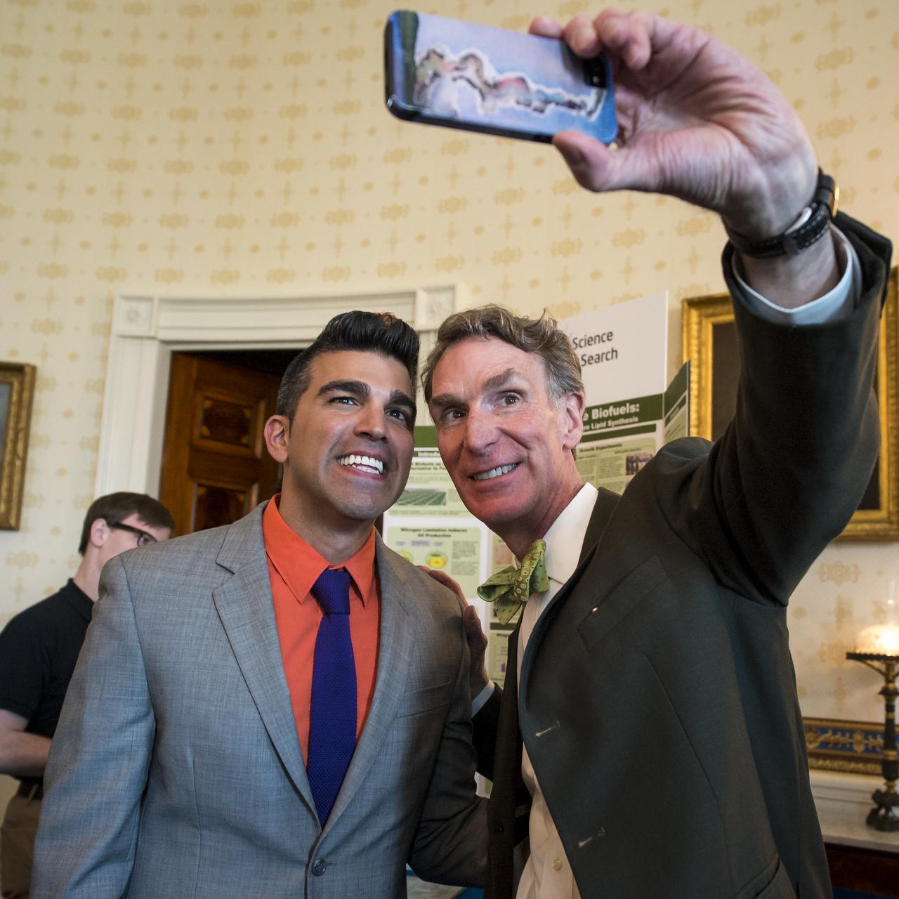 Planetary Society Executive Director and “Bill Nye the Science Guy” host Bill Nye, right, photographs himself with NASA Mars Curiosity Landing mission controller, Bobak "Mohawk Guy" Ferdowsi, during the White House Science Fair held at the White House, April 22, 2013. The science fair celebrated student winners of a broad range of science, technology, engineering and math (STEM) competitions from across the country.  Photo Credit: (NASA/Bill Ingalls)