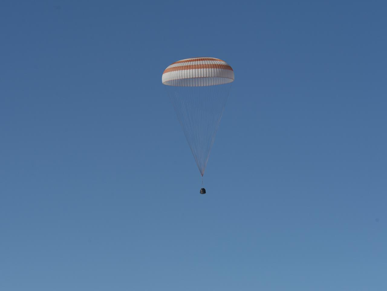 The Soyuz TMA-07M spacecraft is seen as it lands with Expedition 35 Commander Chris Hadfield of the Canadian Space Agency (CSA), NASA Flight Engineer Tom Marshburn and Russian Flight Engineer Roman Romanenko of the Russian Federal Space Agency (Roscosmos) in a remote area near the town of Zhezkazgan, Kazakhstan, on Tuesday, May 14, 2013.  Hadfield, Marshburn and Romanenko returned from five months onboard the International Space Station where they served as members of the Expedition 34 and 35 crews. Photo Credit:  (NASA/Carla Cioffi)