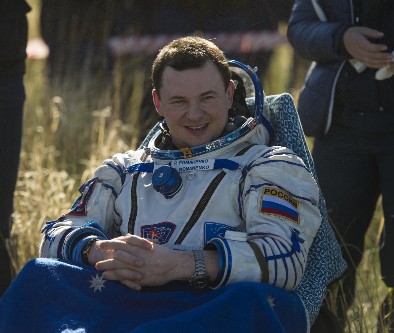 Expedition 35 Flight Engineer and Russian cosmonaut Roman Romanenko smiles as he rests outside of the Soyuz TMA-07M spacecraft shortly after the capsule landed with Expedition 35 Commander Chris Hadfield of the Canadian Space Agency (CSA) and NASA Flight Engineer Tom Marshburn in a remote area outside of the town of Zhezkazgan, Kazakhstan on Tuesday, May 14, 2013.  Romanenko, Hadfield and Marshburn are returning from five months onboard the International Space Station where they served as members of the Expedition 34 and 35 crews.  Photo Credit: (NASA/Carla Cioffi)