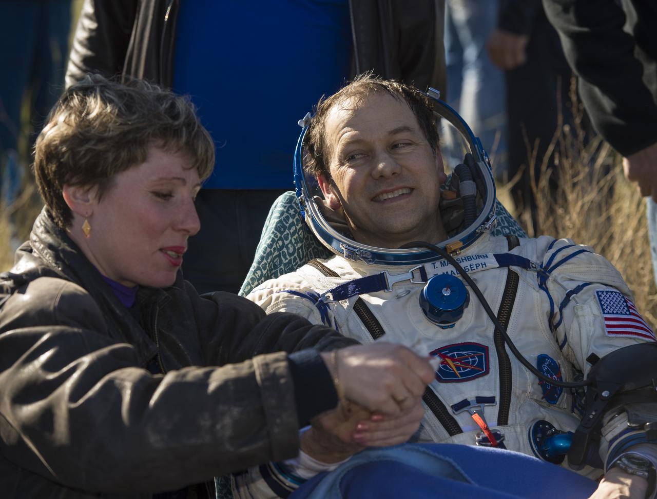 Expedition 35 NASA Flight Engineer Tom Marshburn is attended to by his nurse following his landing in the Soyuz TMA-07M spacecraft in a remote area near the town of Zhezkazgan, Kazakhstan, Tuesday, May 14, 2013. Marshburn and crew mates Expedition 35 Commander Chris Hadfield of the Canadian Space Agency (CSA) and Russian Flight Engineer Roman Romanenko of the Russian Federal Space Agency (Roscosmos) returned to earth from more than five months onboard the International Space Station where they served as members of the Expedition 34 and 35 crews. Photo Credit: (NASA/Carla Cioffi)