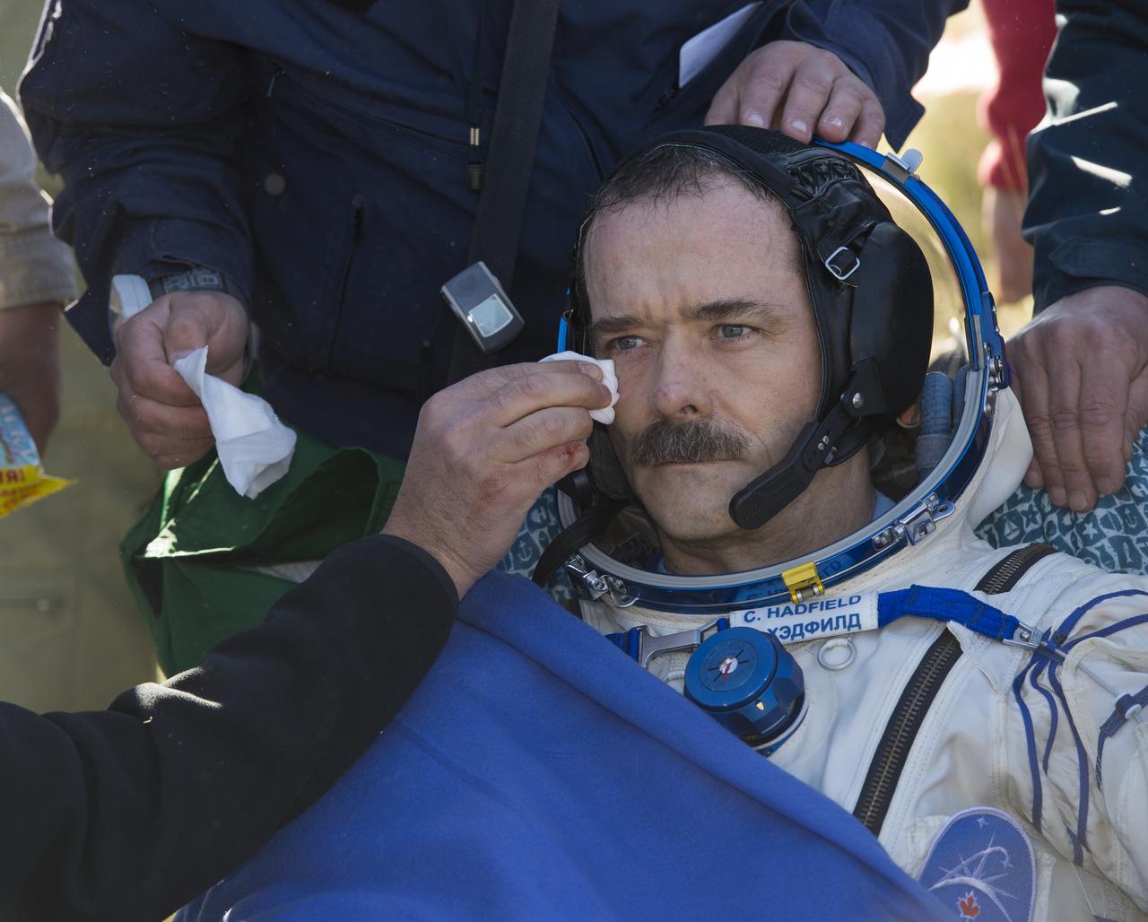 Expedition 35 Commander Chris Hadfield of the Canadian Space Agency (CSA) is attended to following his landing in the Soyuz TMA-07M spacecraft in a remote area near the town of Zhezkazgan, Kazakhstan, Tuesday, May 14, 2013. Hadfield and crew mates NASA Flight Engineer Tom Marshburn and Russian Flight Engineer Roman Romanenko of the Russian Federal Space Agency (Roscosmos) returned to earth from more than five months onboard the International Space Station where they served as members of the Expedition 34 and 35 crews. Photo Credit: (NASA/Carla Cioffi)