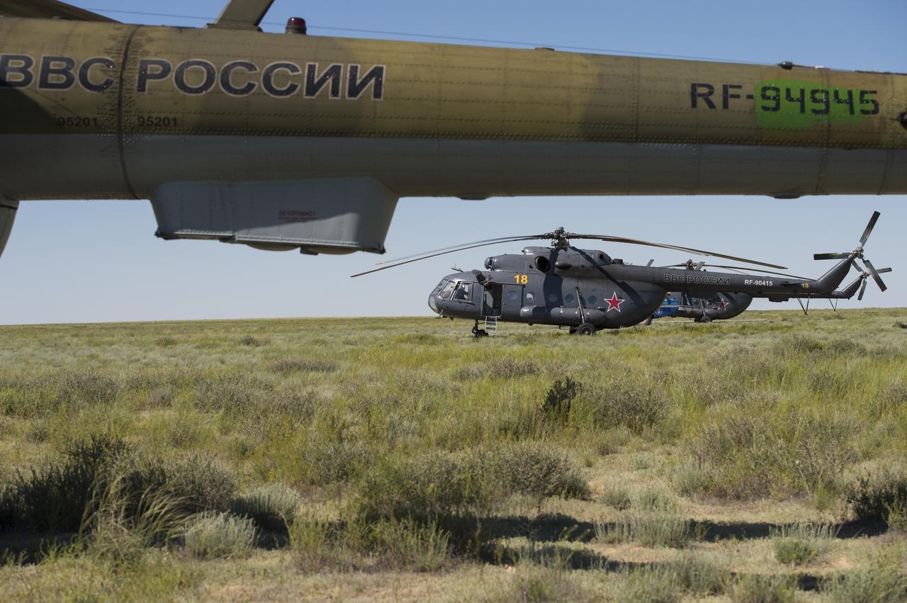 Russian Search and Rescue Helicopters are seen as they await departure from the landing zone in a remote area near the town of Zhezkazgan, Kazakhstan following the the landing of the Soyuz TMA-07M spacecraft on Tuesday, May 14, 2013.  The Soyuz spacecraft delivered Expedition 35 Commander Chris Hadfield of the Canadian Space Agency (CSA), NASA Flight Engineer Tom Marshburn and Russian Flight Engineer Roman Romanenko after having spent five months onboard the International Space Station where they served as members of the Expedition 34 and 35 crews.  Photo Credit:  (NASA/Carla Cioffi)