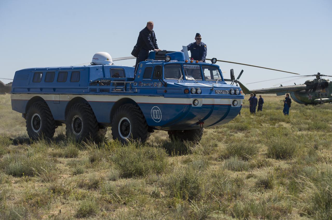 A Russian all terrain vehicle (ATV) takes Expedition 35 NASA Flight Engineer Tom Marshburn to a helicopter from the Soyuz TMA-07M spacecraft shortly after the capsule landed with Marshburn and Expedition 35 Commander Chris Hadfield of the Canadian Space Agency (CSA) and Russian Flight Engineer Roman Romanenko in a remote area near the town of Zhezkazgan, Kazakhstan, Tuesday, May 14, 2013. Marshburn, Hadfield and Romanenko are returning from five months onboard the International Space Station where they served as members of the Expedition 34 and 35 crews.  Photo Credit: (NASA/Carla Cioffi)