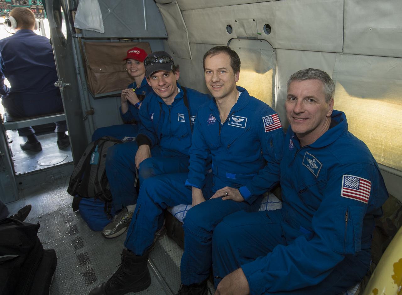 Expedition 35 NASA Flight Engineer Tom Marshburn, center, is seen on a Russian Search and Rescue helicopter just before arriving at Karaganda Airport in Kazakhstan following his landing in the Soyuz TMA-07M spacecraft in a remote area near the town of Zhezkazgan, Kazakhstan, Tuesday, May 14, 2013. Marshburn, Expedition 35 Commander Chris Hadfield of the Canadian Space Agency (CSA) and Russian Flight Engineer Roman Romanenko of the Russian Federal Space Agency (Roscosmos) returned to earth from more than five months onboard the International Space Station where they served as members of the Expedition 34 and 35 crews. Photo Credit: (NASA/Carla Cioffi)