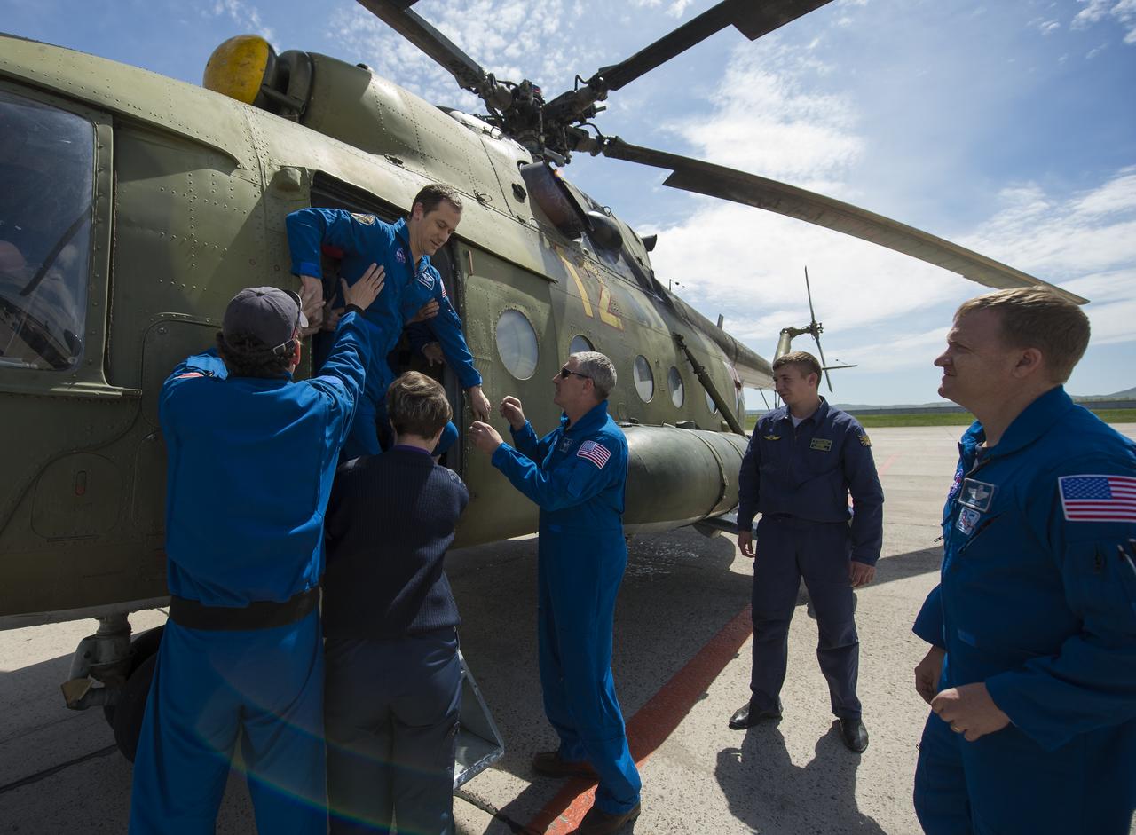 Expedition 35 NASA Flight Engineer Tom Marshburn is helped off a Russian Search and Rescue helicopter at Karaganda Airport in Kazakhstan following his landing in the Soyuz TMA-07M spacecraft in a remote area near the town of Zhezkazgan, Kazakhstan, Tuesday, May 14, 2013. Marshburn, Expedition 35 Commander Chris Hadfield of the Canadian Space Agency (CSA) and Russian Flight Engineer Roman Romanenko of the Russian Federal Space Agency (Roscosmos) returned to earth from more than five months onboard the International Space Station where they served as members of the Expedition 34 and 35 crews. Photo Credit: (NASA/Carla Cioffi)