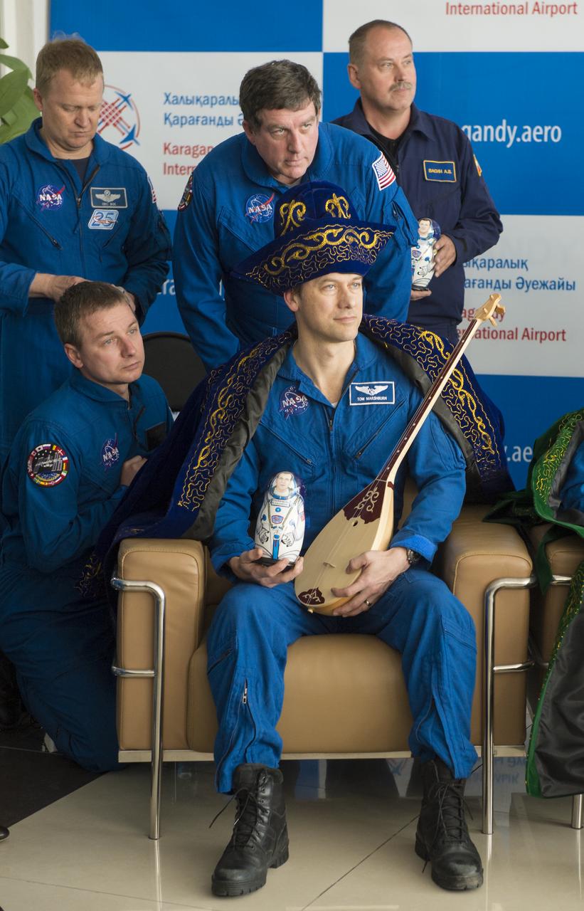Expedition 35 NASA Flight Engineer Tom Marshburn is seen in a gift of traditional Kazakhstan dress during a welcome ceremony at the Karaganda Airport in Kazakhstan on Tuesday, May 14, 2013. Marshburn, Expedition 35 Commander Chris Hadfield of the Canadian Space Agency (CSA) and Russian Flight Engineer Roman Romanenko of the Russian Federal Space Agency (Roscosmos) returned to earth from more than five months onboard the International Space Station where they served as members of the Expedition 34 and 35 crews. Photo Credit: (NASA/Carla Cioffi)