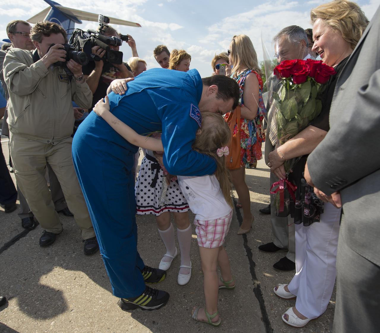 Expedition 35 Russian Flight Engineer Roman Romanenko of the Russian Federal Space Agency (Roscosmos) greets his children upon his return home at Chkalovsky Airport in Russia, Tuesday, May 14, 2013.  Photo Credit:  (NASA/Carla Cioffi)