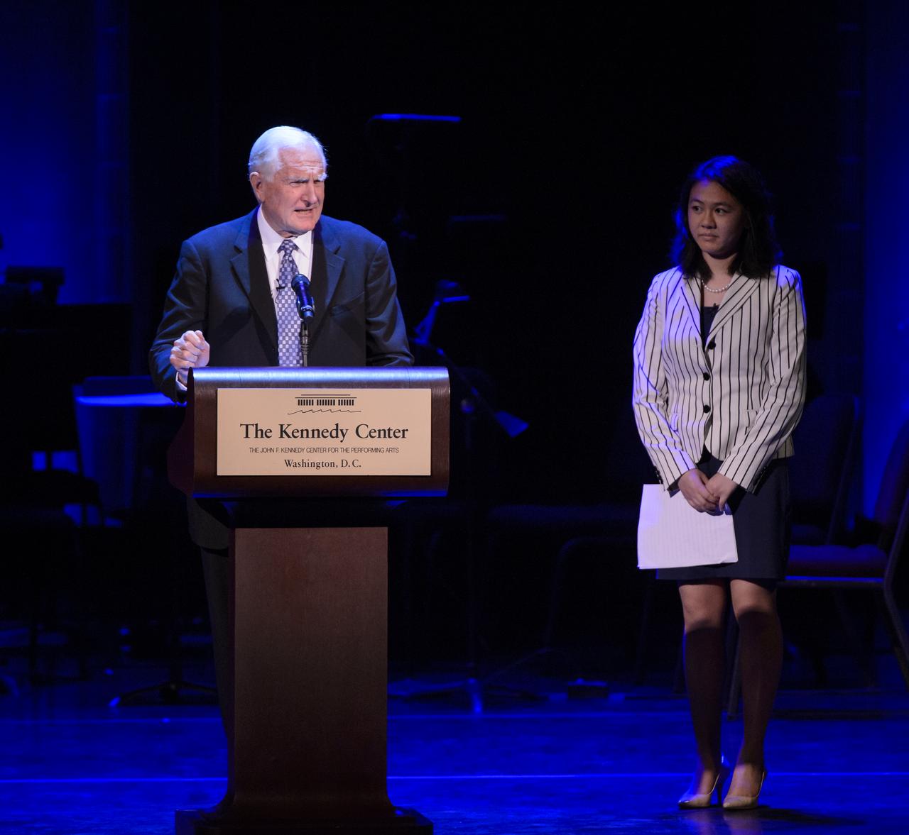 Craig Barrett, retired CEO and Chairman of Intel, speaks of Sally Ride's impact on support for STEM education in corporate America as Alice Zhao, Harvard University student looks on during the National Tribute to Sally Ride at the John F. Kennedy Center for the Performing Arts, Monday, May 20, 2013 in Washington. Photo Credit: (NASA/Bill Ingalls)