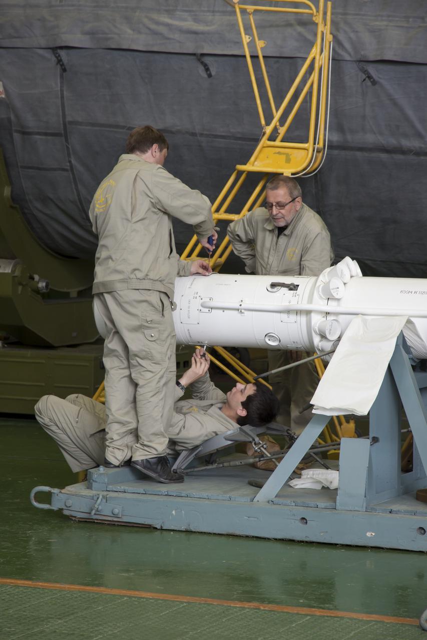Engineers work on the emergency escape tower of the Soyuz TMA-09M spacecraft prior to it being mated to the Soyuz rocket at the Baikonur Cosmodrome, Saturday, May 25, 2013, in Kazakhstan. The launch of the Soyuz rocket to the International Space Station (ISS) with Expedition 36/37 Soyuz Commander Fyodor Yurchikhin of the Russian Federal Space Agency (Roscosmos), Flight Engineers; Luca Parmitano of the European Space Agency, and Karen Nyberg of NASA, is scheduled for Wednesday May 29, Kazakh time. Yurchikhin, Nyberg, and, Parmitano, will remain aboard the station until mid-November. Photo credit: (NASA/Victor Zelentsov)