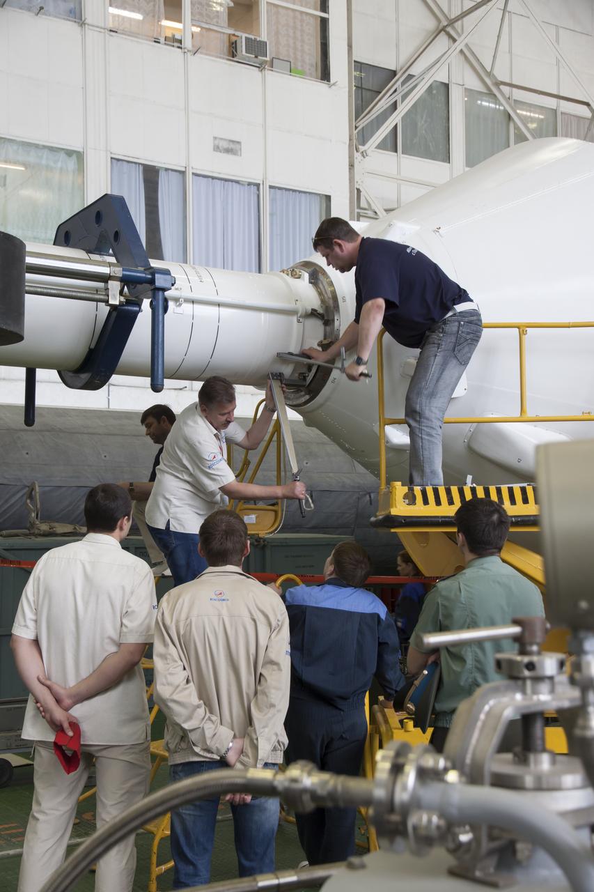 Engineers attach the escape tower to the Soyuz TMA-09M spacecraft during assembly of the Soyuz rocket at the Baikonur Cosmodrome, Saturday, May 25, 2013, in Kazakhstan. The launch of the Soyuz rocket to the International Space Station (ISS) with Expedition 36/37 Soyuz Commander Fyodor Yurchikhin of the Russian Federal Space Agency (Roscosmos), Flight Engineers; Luca Parmitano of the European Space Agency, and Karen Nyberg of NASA, is scheduled for Wednesday May 29, Kazakh time. Yurchikhin, Nyberg, and, Parmitano, will remain aboard the station until mid-November. Photo credit: (NASA/Victor Zelentsov)