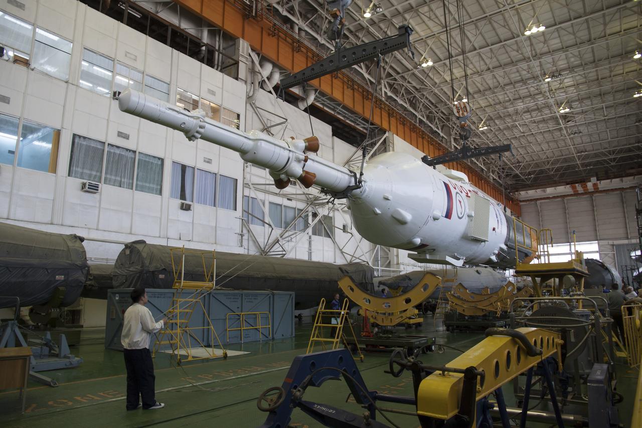 An technician helps guide the Soyuz rocket during the assembly at the Baikonur Cosmodrome, Saturday, May 25, 2013, in Kazakhstan. The launch of the Soyuz rocket and TMA-09M spacecraft to the International Space Station (ISS) with Expedition 36/37 Soyuz Commander Fyodor Yurchikhin of the Russian Federal Space Agency (Roscosmos), Flight Engineers; Luca Parmitano of the European Space Agency, and Karen Nyberg of NASA, is scheduled for Wednesday May 29, Kazakh time. Yurchikhin, Nyberg, and, Parmitano, will remain aboard the station until mid-November. Photo credit: (NASA/Victor Zelentsov)