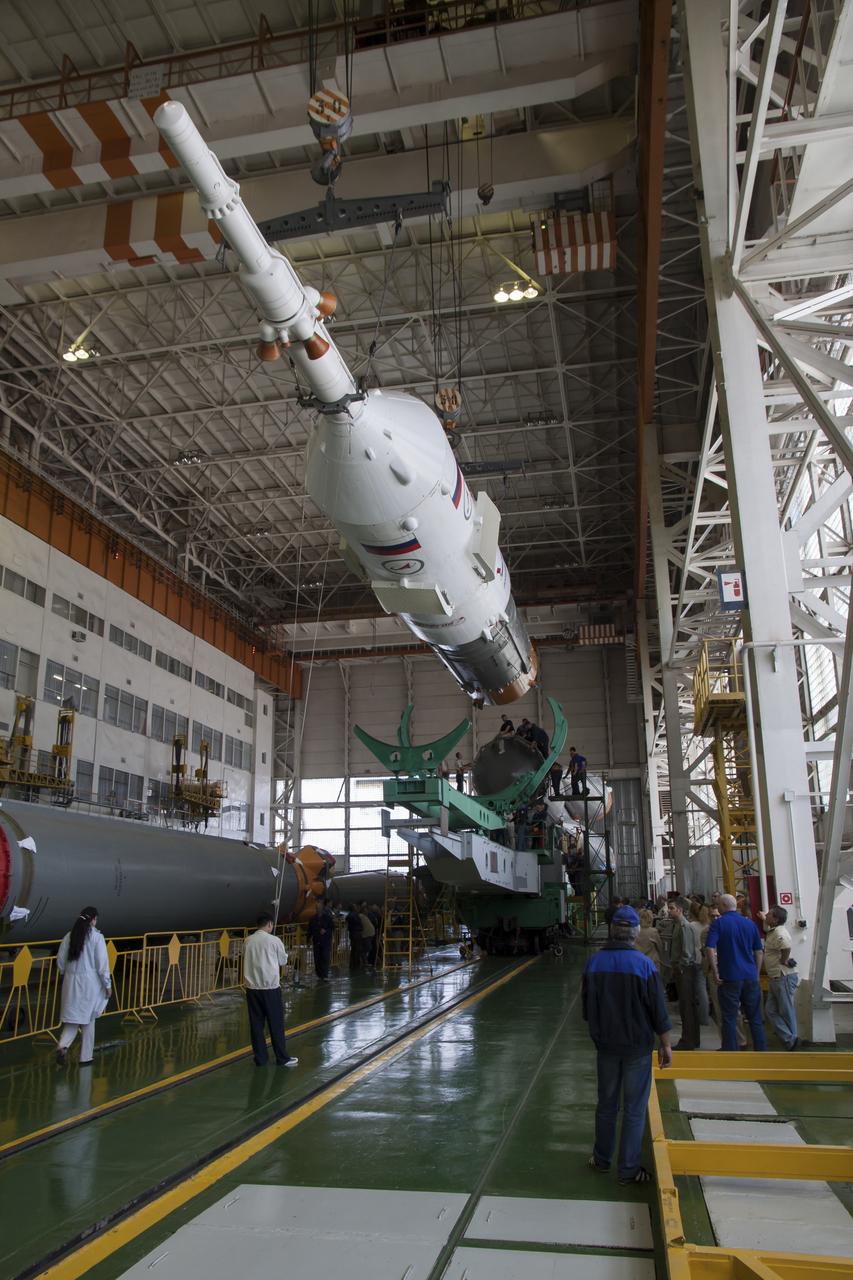 Technicians work on the Soyuz rocket during the assembly at the Baikonur Cosmodrome, Saturday, May 25, 2013, in Kazakhstan. The launch of the Soyuz rocket and TMA-09M spacecraft to the International Space Station (ISS) with Expedition 36/37 Soyuz Commander Fyodor Yurchikhin of the Russian Federal Space Agency (Roscosmos), Flight Engineers; Luca Parmitano of the European Space Agency, and Karen Nyberg of NASA, is scheduled for Wednesday May 29, Kazakh time. Yurchikhin, Nyberg, and, Parmitano, will remain aboard the station until mid-November. Photo credit: (NASA/Victor Zelentsov)